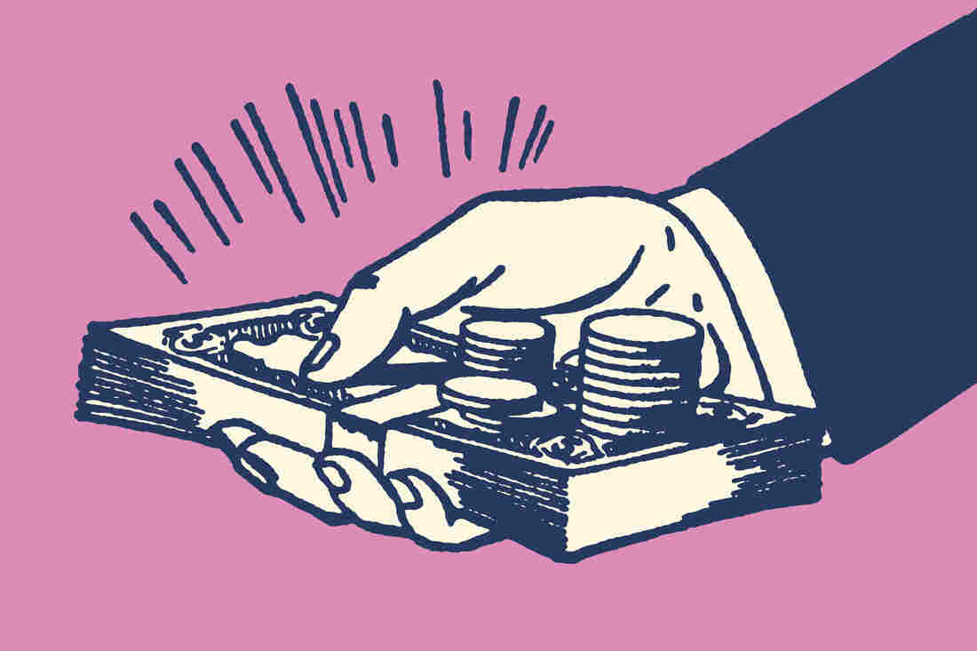 A hand holding out cash.