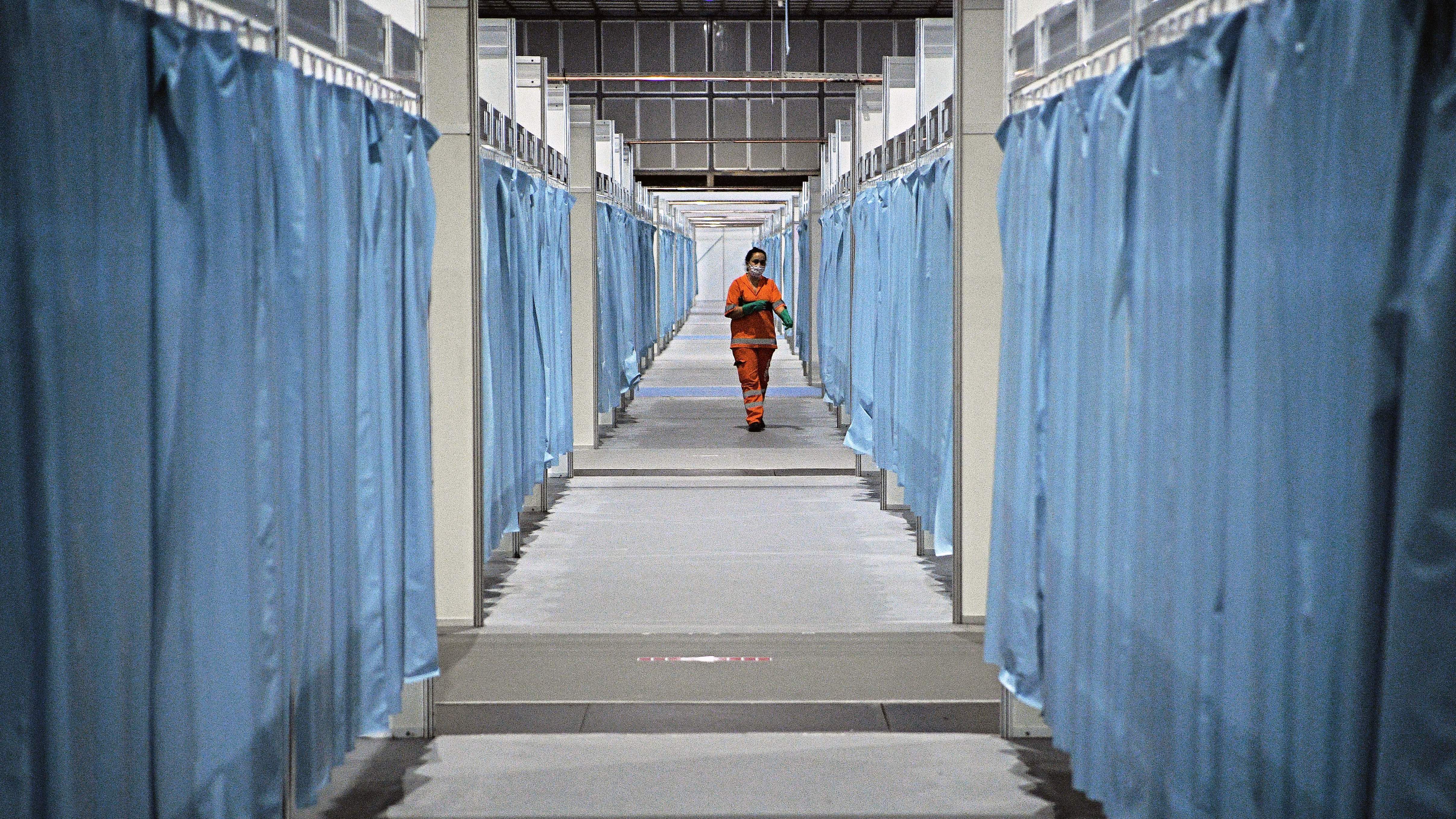 A custodian walks down the corridor of a field hospital set up for COVID-19 patients in Rio de Janeiro. Brazil has emerged as a new hot spot of the coronavirus, which in a span of just three months has reached virtually every country in the world. (AFP via Getty Images)