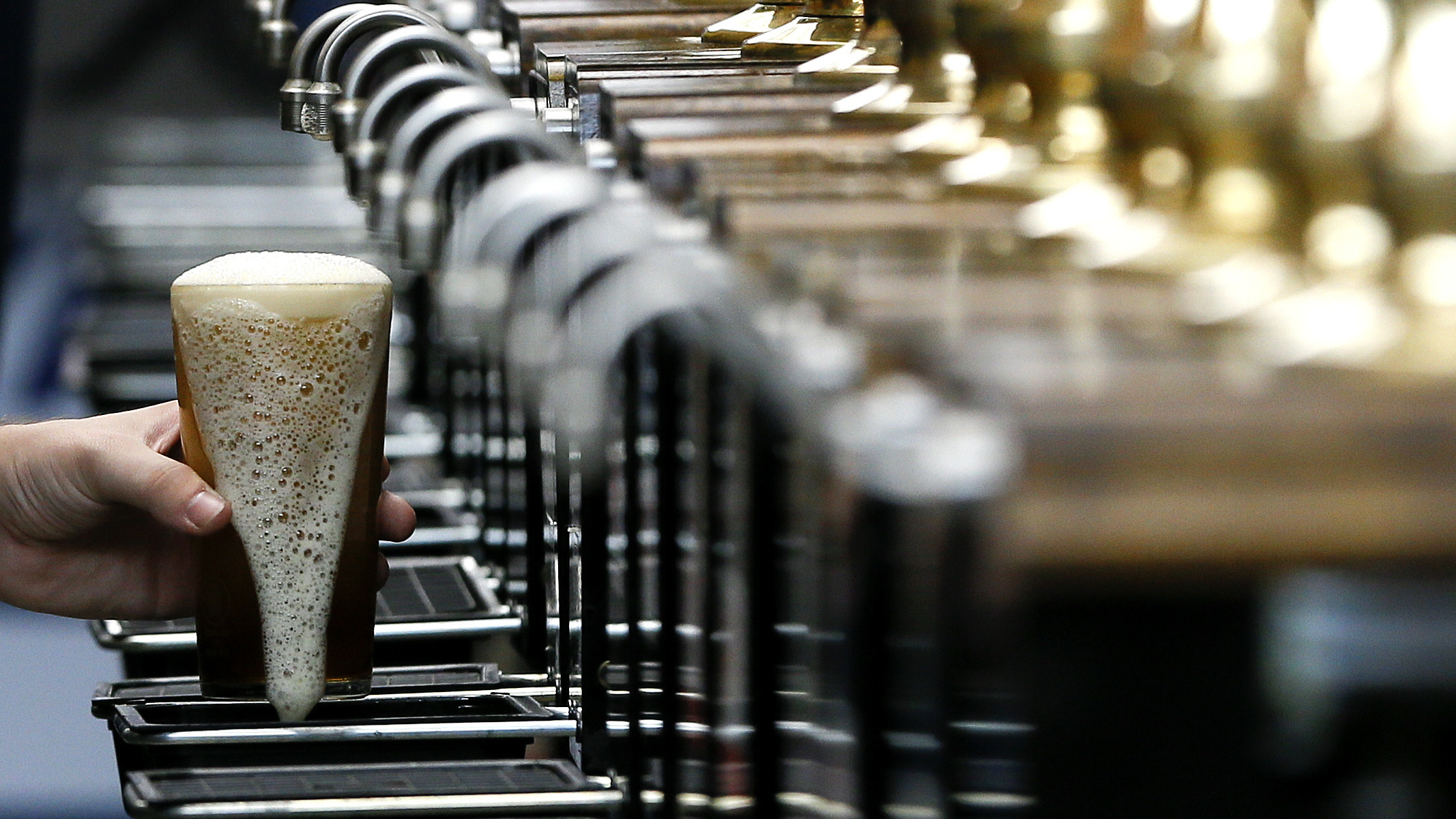 A pint of beer is poured at the 2015 Great British Beer Festival in London. A brewery in the northeast of England is giving away beer to help raise money for the National Health Service during the coronavirus pandemic.