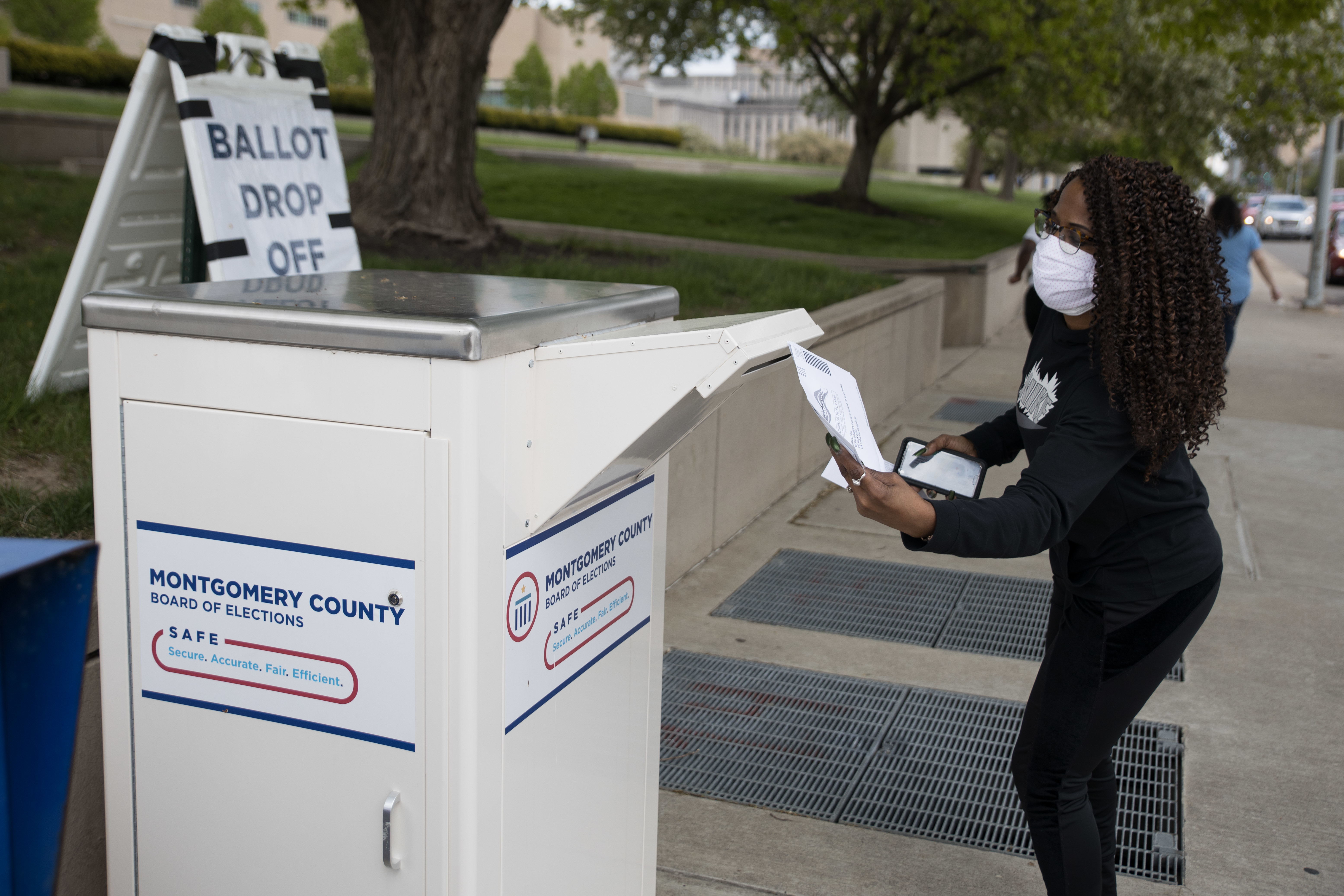 An Ohio voter drops off her ballot at the Board of Elections in Dayton earlier this week. Legal fights around mail-in voting are heating up as states turn to the practice amid the coronavirus pandemic. (AFP via Getty Images)