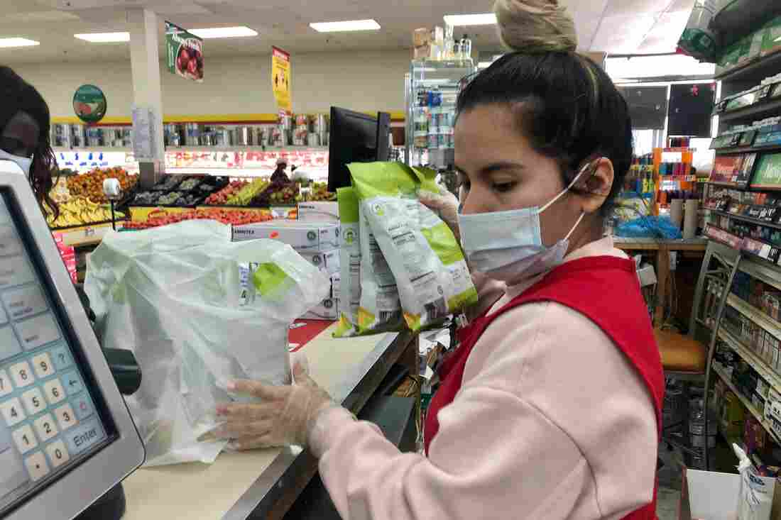 Fatima, an essential grocery worker at a store called Compare Foods in Greensboro, North Carolina.