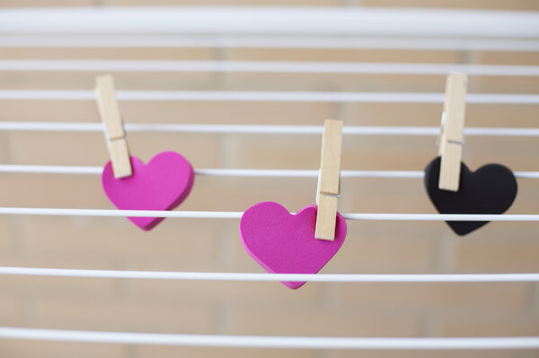 three hearts held on clothes pins