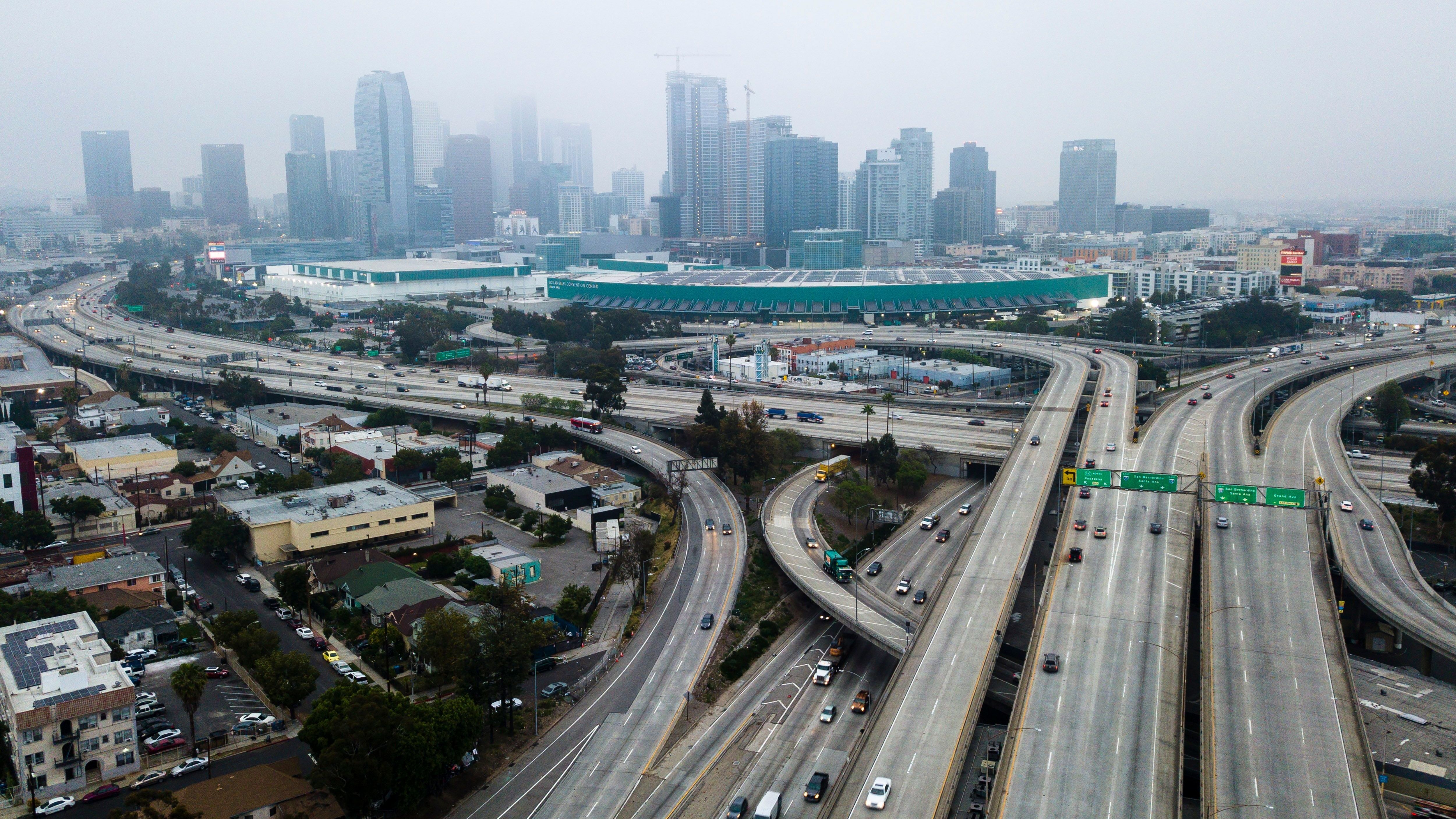 An aerial view shows downtown Los Angeles on April 30. U.S. miles driven decreased remarkably quickly in March, and driving slowly started to resume again — while remaining well below typical levels. (AFP via Getty Images)
