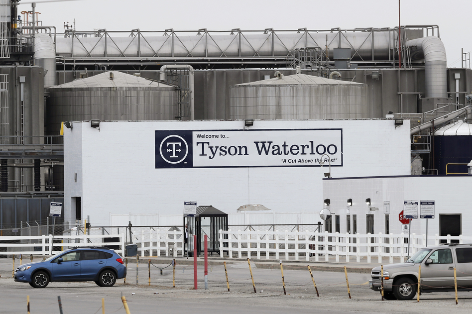 Vehicles sit in a near empty parking lot outside the Tyson Foods plant in Waterloo, Iowa, on May 1. (Charlie Neibergall/AP)
