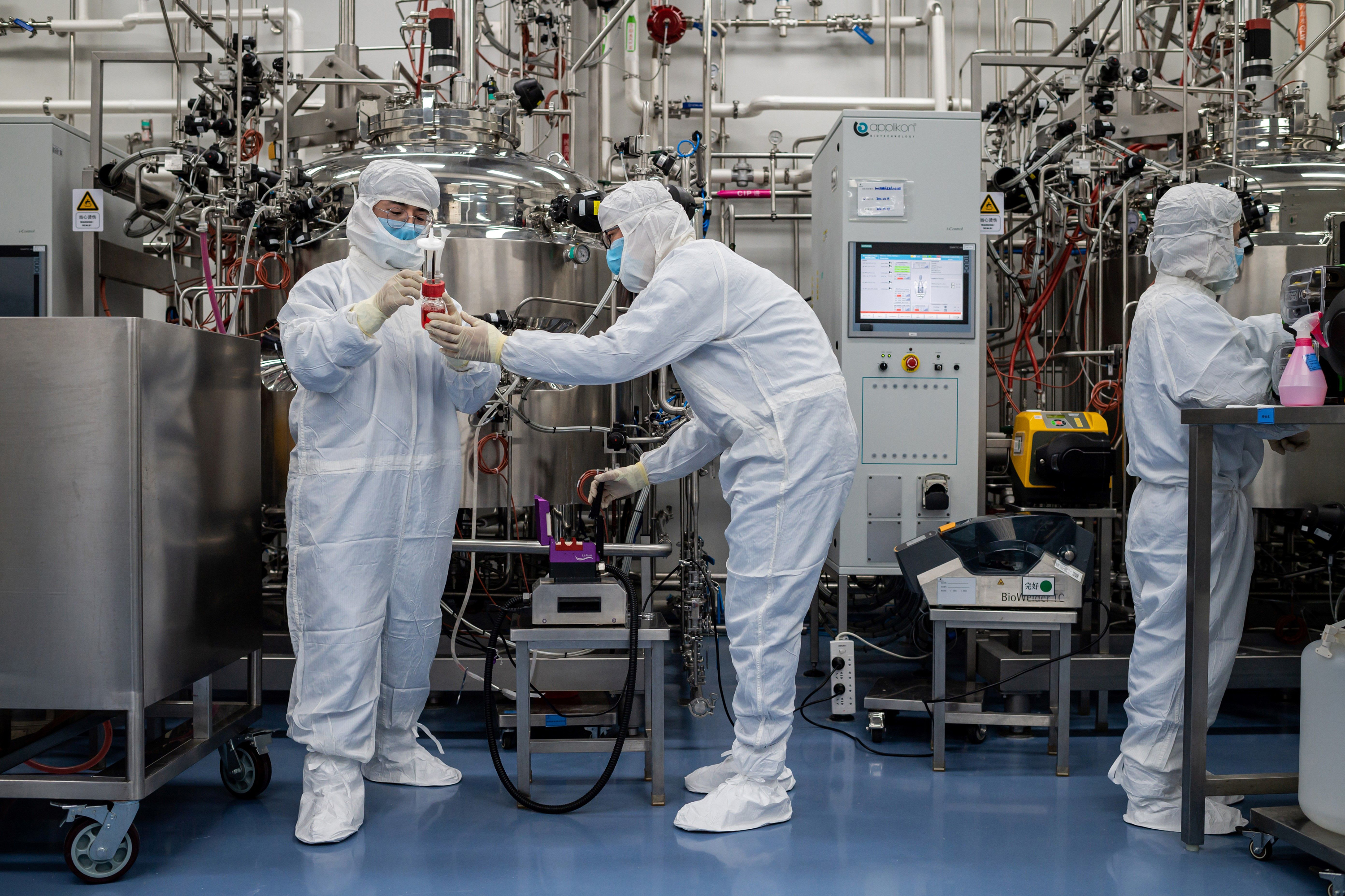 Engineers work on a potential vaccine for the coronavirus at a Beijing lab. (AFP via Getty Images)
