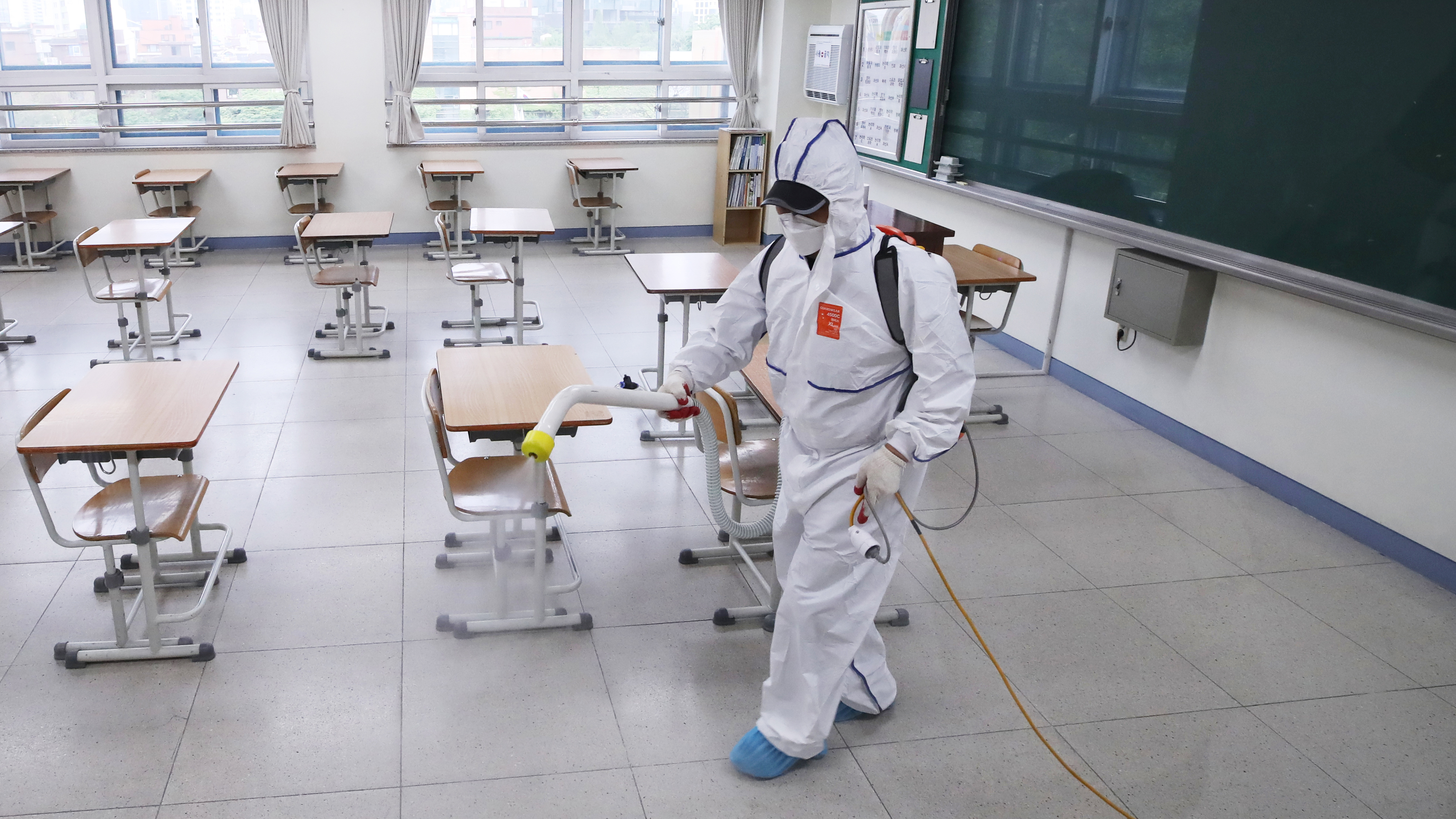 A person sprays disinfectant at a high school amid the coronavirus outbreak on Monday, in Seoul, South Korea.