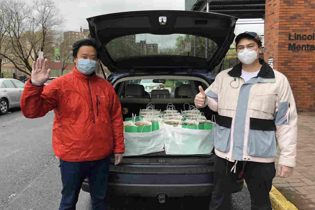NEW YORK, April 27, 2020. Justin Udry R, assistant manager on marketing and technology with Junzi Kitchen, and Andrew Chu, operations and catering manager with Junzi Kitchen, pose for a photo.