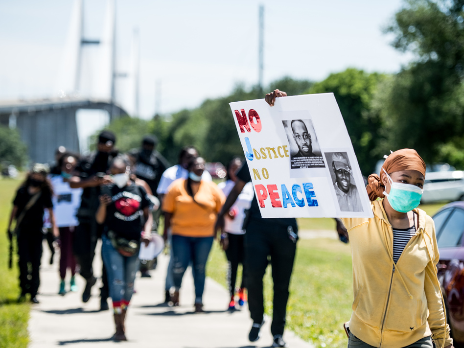 People return to their vehicles after gathering to honor the life of Ahmaud Arbery at Sidney Lanier Park on May 9 in Brunswick, Ga. Arbery was shot and killed while jogging in the nearby Satilla Shores neighborhood on Feb. 23. (Sean Rayford/Getty Images)