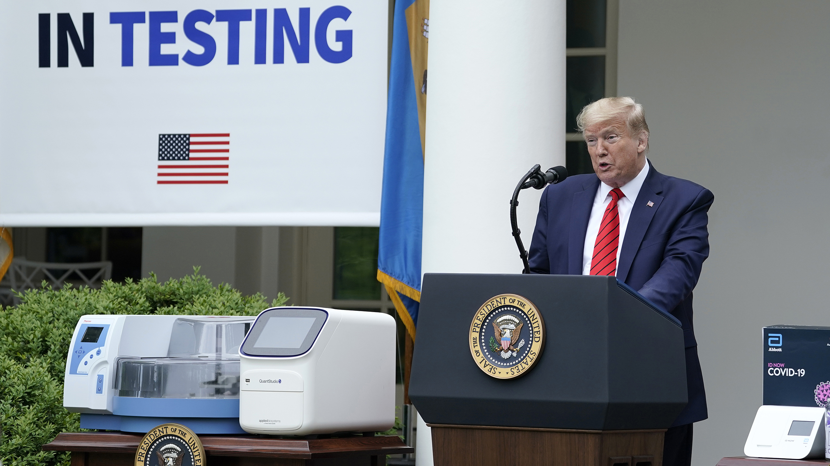 President Donald Trump, flanked by tables holding testing supplies and machines, speaks during a press briefing about coronavirus testing in the Rose Garden of the White House on May 11, 2020 in Washington, D.C. (Getty Images)