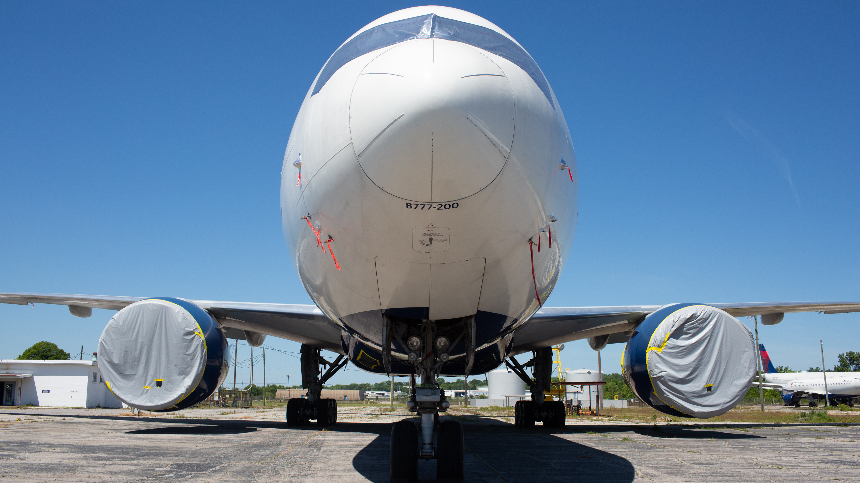 A Delta Boeing 777 stays put in storage at the Birmingham-Shuttlesworth International Airport on May 1. It's one of dozens of Delta planes parked at the airport because of the coronavirus pandemic. (NPR)