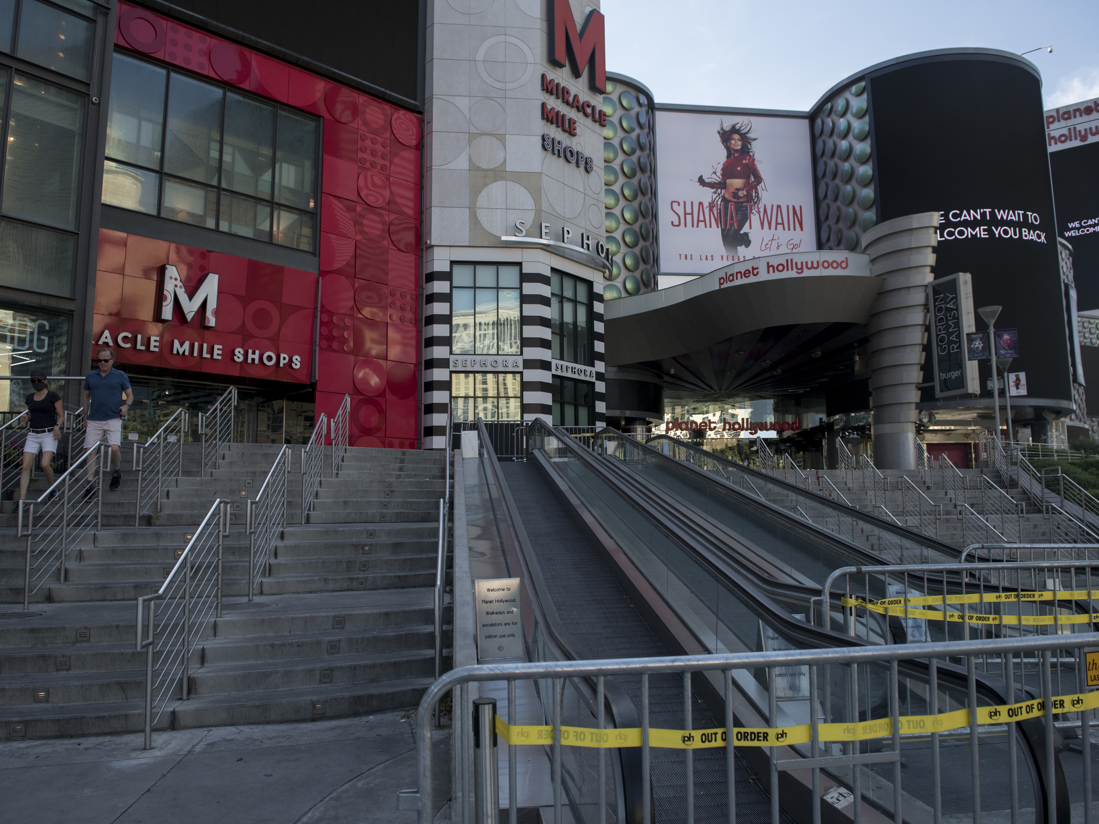 People walk near closed shops on a quiet Las Vegas Strip on May 8. Retail sales dropped a record 16.4% last month. (AFP/Getty Images)