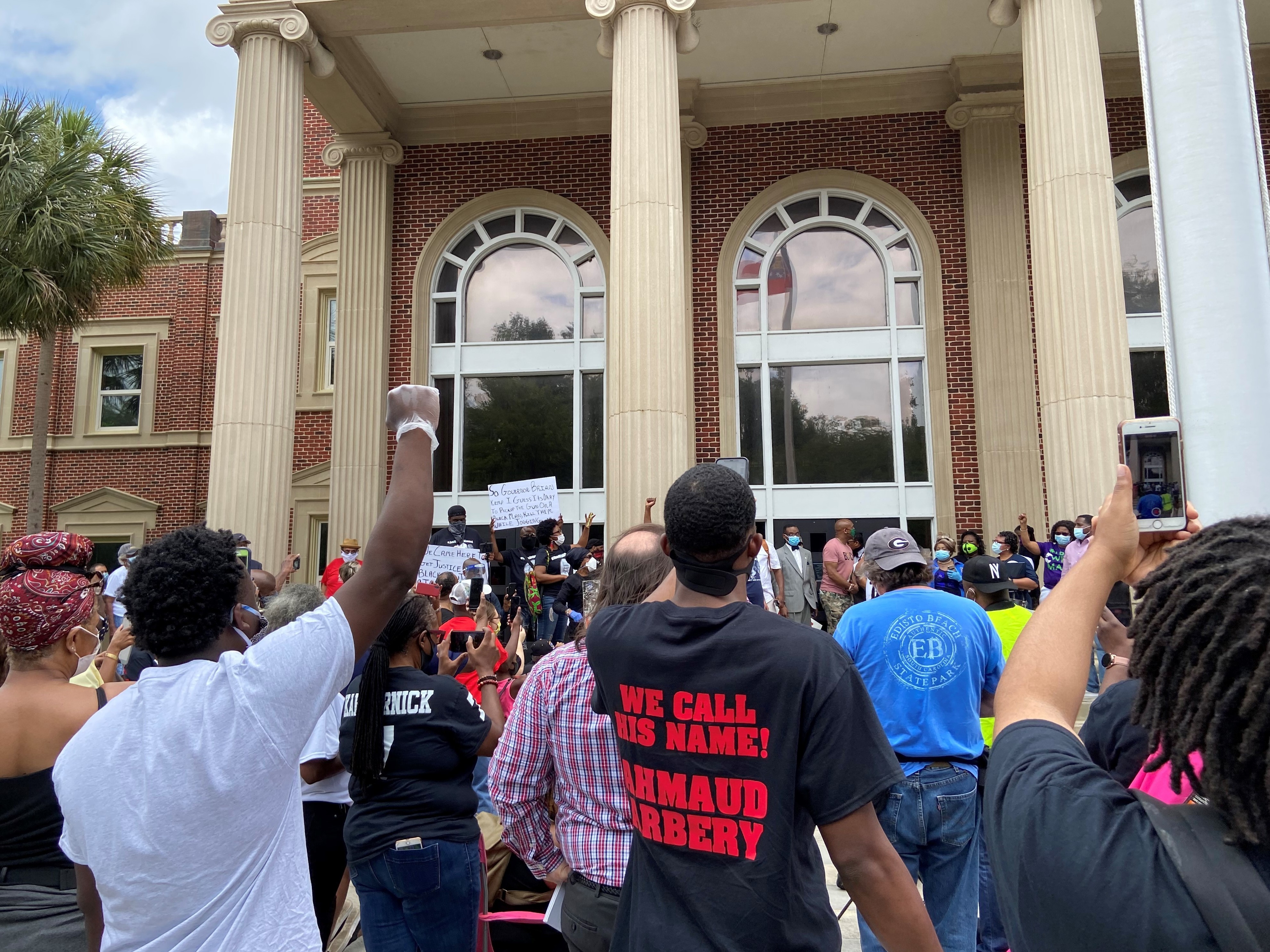 Hundreds of people gathered in front of the Glynn County Courthouse on a recent Saturday in May to demand justice for Ahmaud Arbery, who was shot and killed in February in Brunswick, Ga. (WABE)