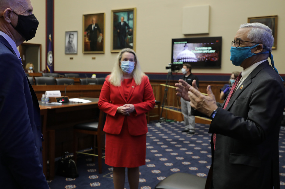 Occupational Safety and Health Administration Principal Deputy Assistant Secretary Loren Sweatt (C) and National Institute for Occupational Safety and Health Director John Howard (L) talk with House Education and Labor Committee Chairman Bobby Scott (D-VA) before a hearing about the federal government's role in protecting workers during the novel coronavirus pandemic on Capitol Hill on Thursday. (Chip Somodevilla/Getty Images)