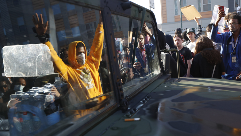 A National Guard vehicle reflects a crowd of protesters Friday in Minneapolis, where Maj. Gen. Jon Jensen said that night's deployment "was not enough" to handle the massive protests over the death of George Floyd. (John Minchillo/AP)