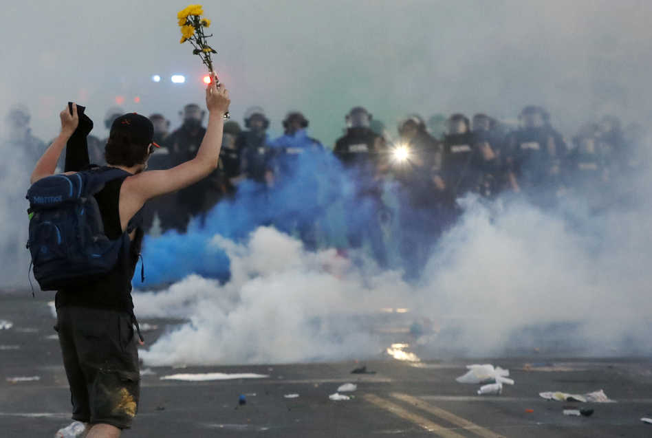Police move towards a protester after curfew Saturday, May 30, 2020, in Minneapolis. (John Minchillo/AP)