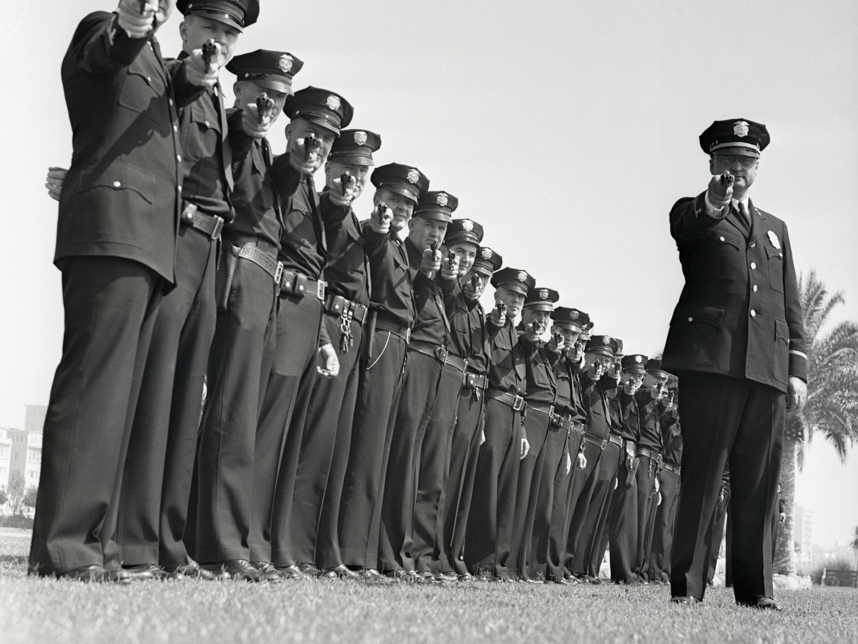 A line of policemen take aim. (Bettmann Archive)