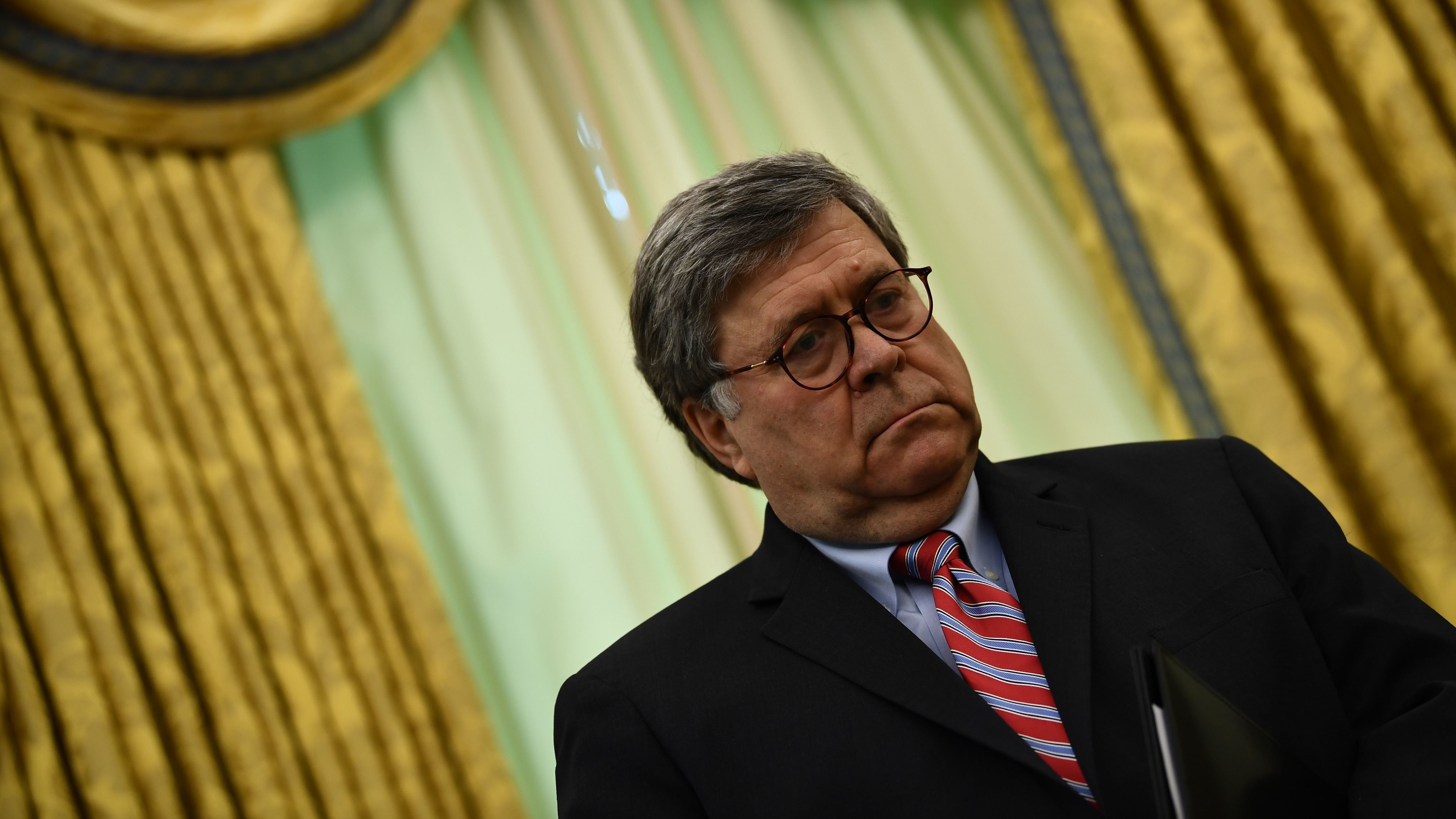 U.S. Attorney General William Barr, pictured last week in the Oval Office, denied that President Trump's controversial visit this week to St. John's Church in Washington, D.C., was a political move. (AFP via Getty Images)