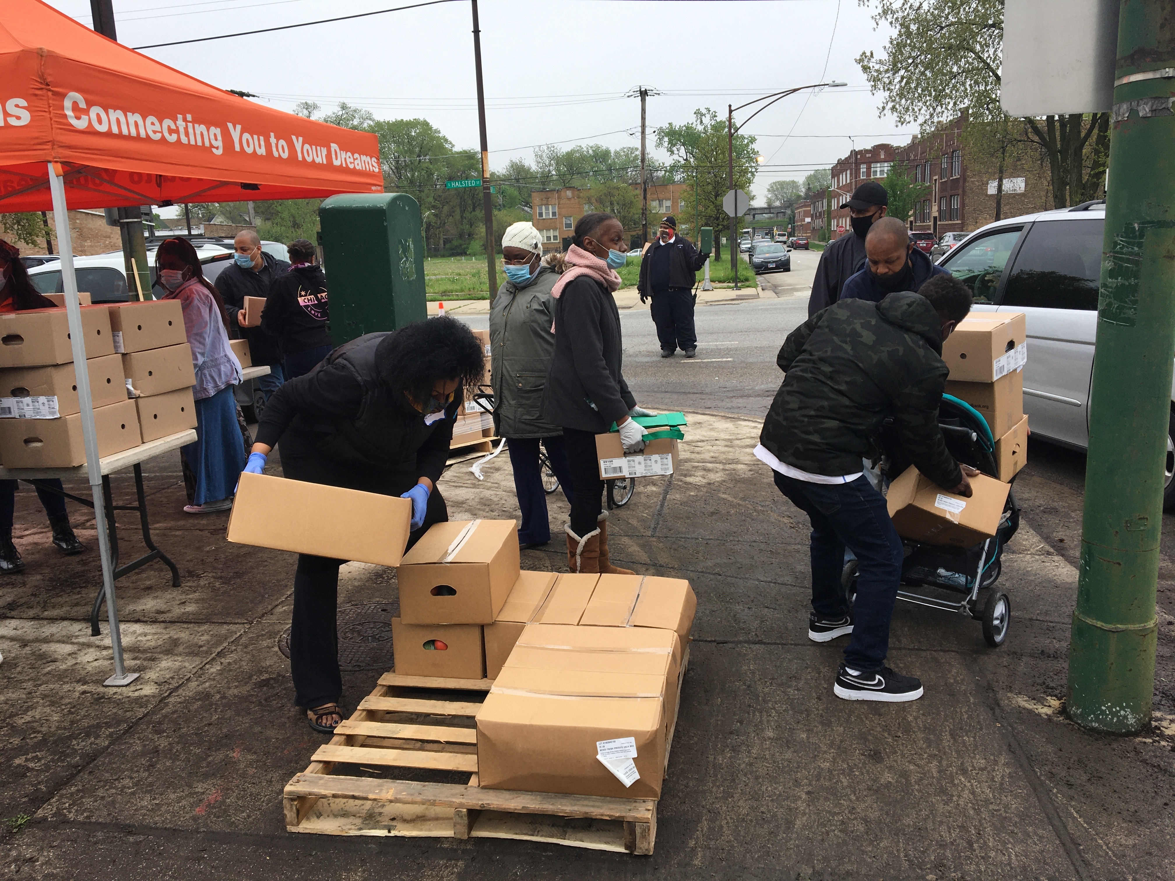 Residents of the Auburn Gresham neighborhood in Chicago line up for boxes of food at a weekly pop-up food pantry. (NPR)