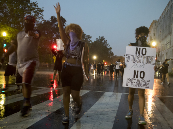 Rain did not dampen the determination of protesters walking on New York Avenue in  Washington, D.C., on Thursday.