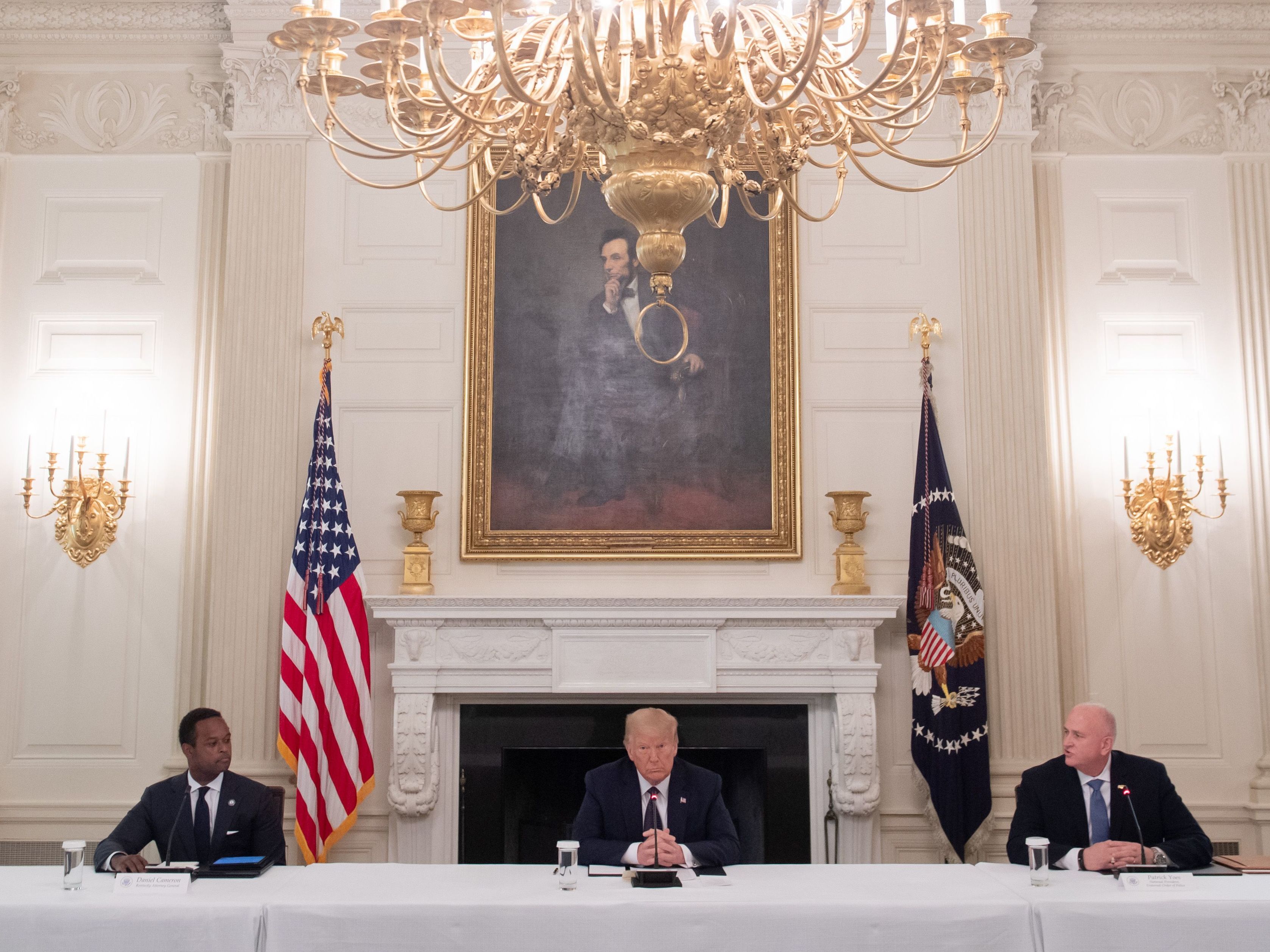 President Trump hosts a roundtable discussion Monday on police and community relations with law enforcement officials in the State Dining Room at the White House. (AFP via Getty Images)