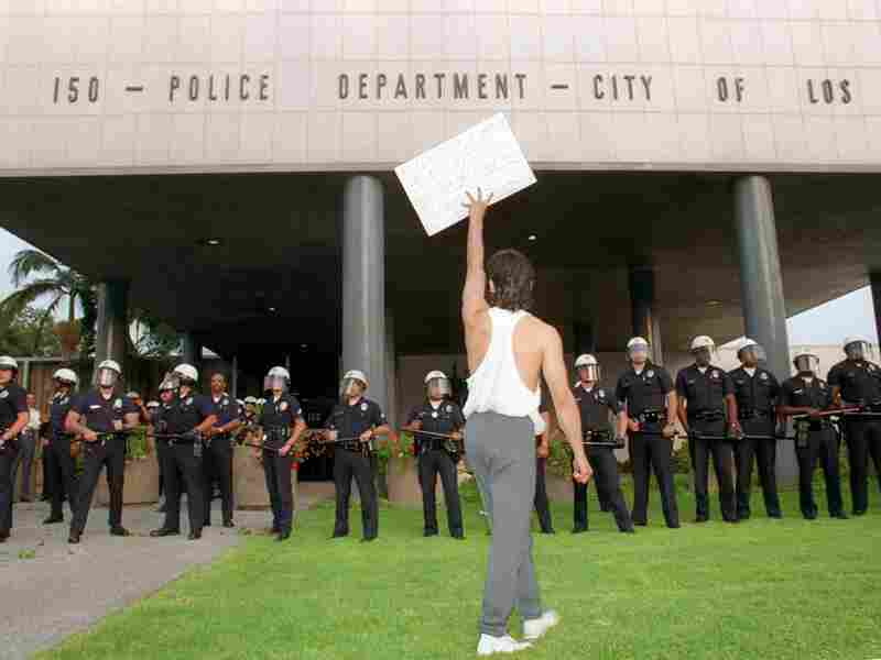 A demonstrator protests the verdict in the trial of four Los Angeles police officers accused of beating motorist Rodney King outside the Los Angeles Police Department headquarters on April 29, 1992. Riots broke out in Los Angeles after a jury acquitted the four police officers accused of beating King.