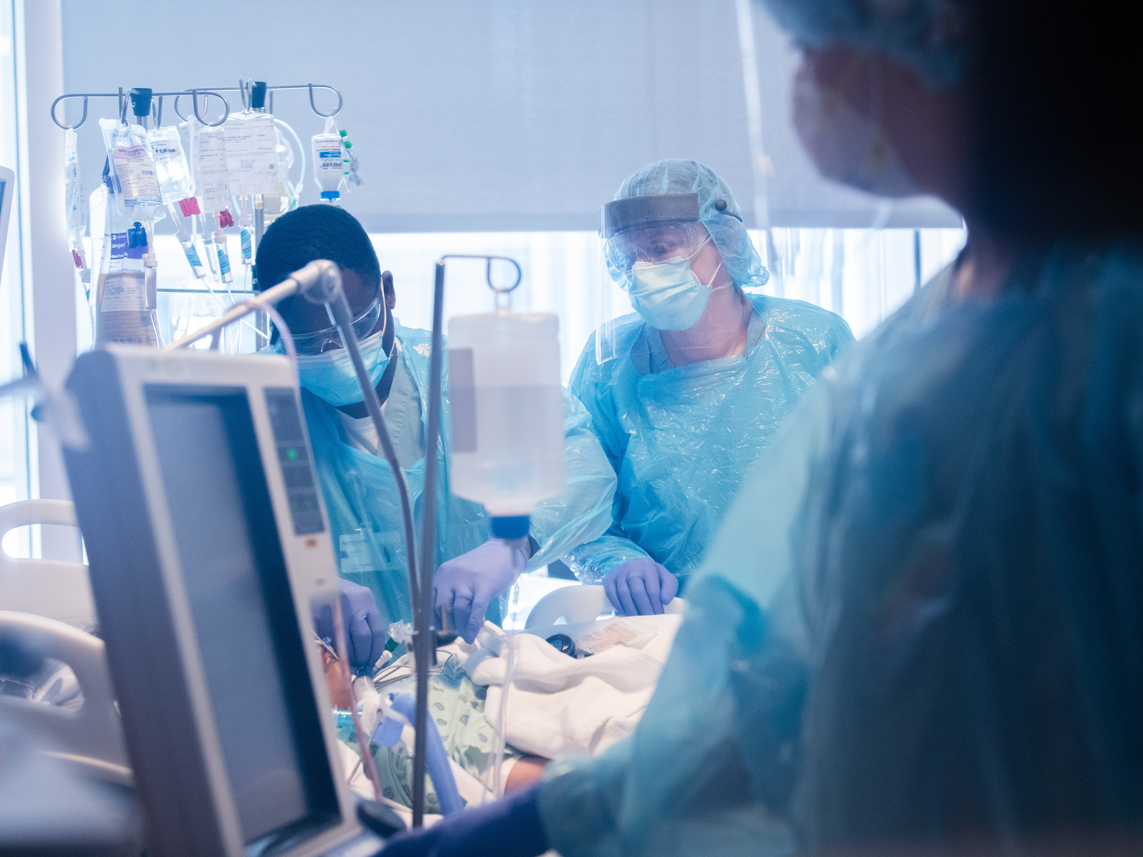 The lungs of a young woman in her 20s became so damaged by COVID-19 that she could not survive without her blood being oxygenated outside her body on an ECMO machine. She received a double-lung transplant on June 5. In this photo taken before the transplant, the patient is being monitored by the ECMO team at Northwestern Memorial Hospital in Chicago. (Northwestern Medicine)