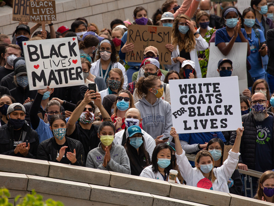 Health workers and others rallied in Seattle during a Doctors For Justice event on June 6, protesting police brutality in the wake of George Floyd's death. Medical training needs a hard look too, doctors say: Students of color and LGBTQ people often bear the brunt of what can be a bullying culture. (David Ryder/Getty Images)