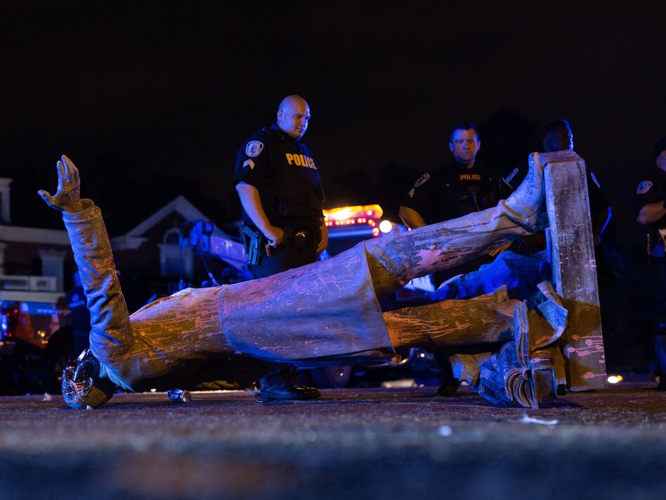 A statue of Confederate States President Jefferson Davis lies on the street after protesters pulled it down in Richmond, Va., on Wednesday. (Parker Michels-Boyce/AFP via Getty Images)