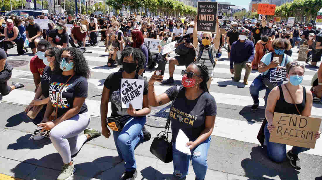 Hundreds of protesters rally outside City Hall on Tuesday, June 9, 2020, in San Francisco, California. Protestors are seen holding signs and kneeling. (Santiago Mejia/The San Francisco Chronicle via Getty Images)