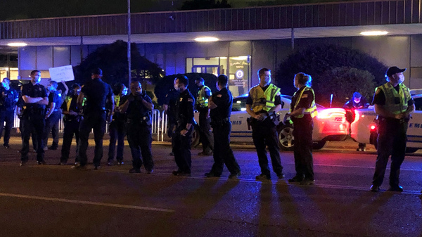 Officers form a line in front of a police precinct May 27, during a protest over the death of George Floyd.