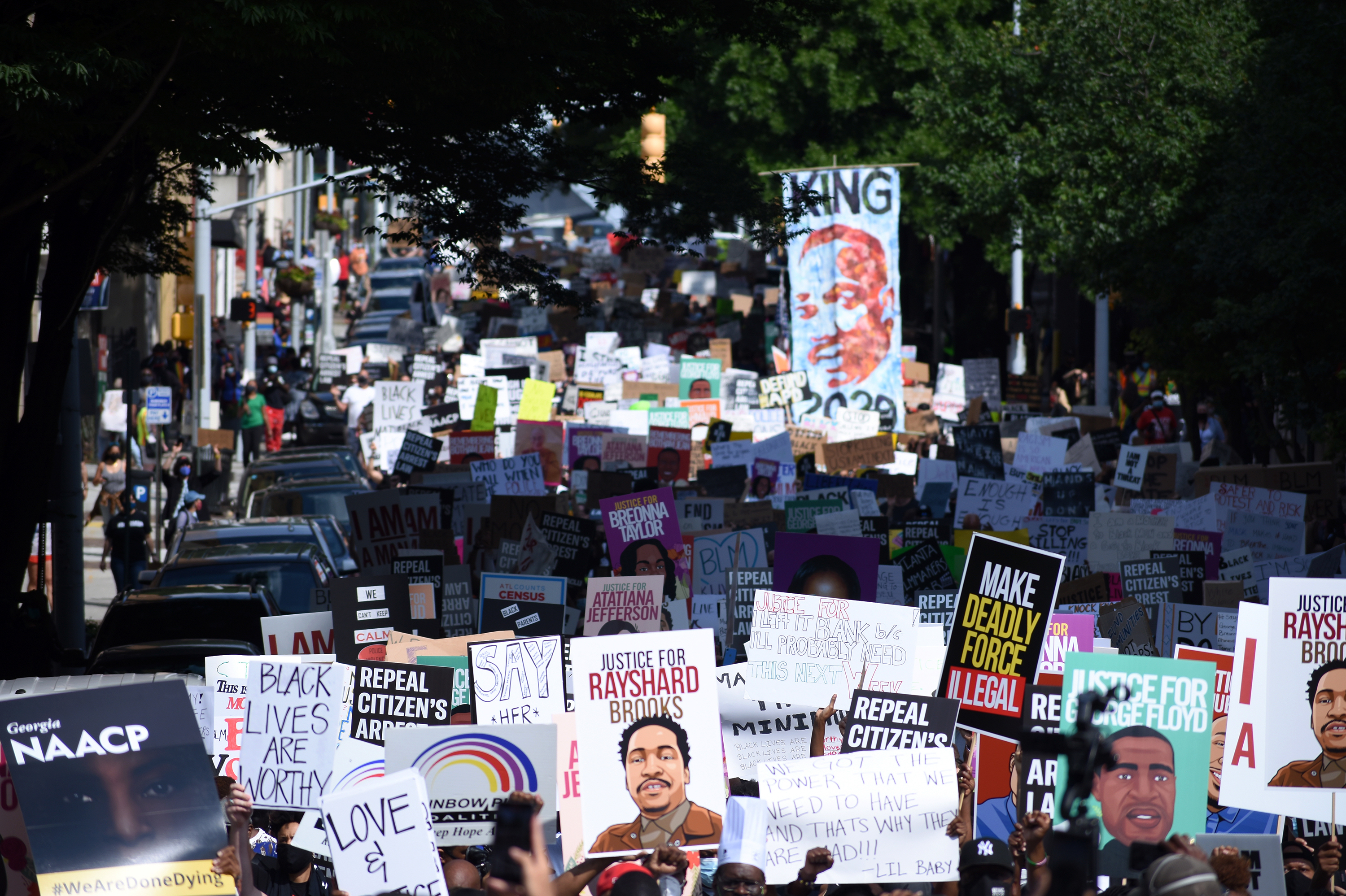 Protesters march against police violence in Atlanta on Monday. The event coincides with state lawmakers returning to work after the session was halted for three months amid concern about the spread of the coronavirus. (Georgia Public Broadcasting)