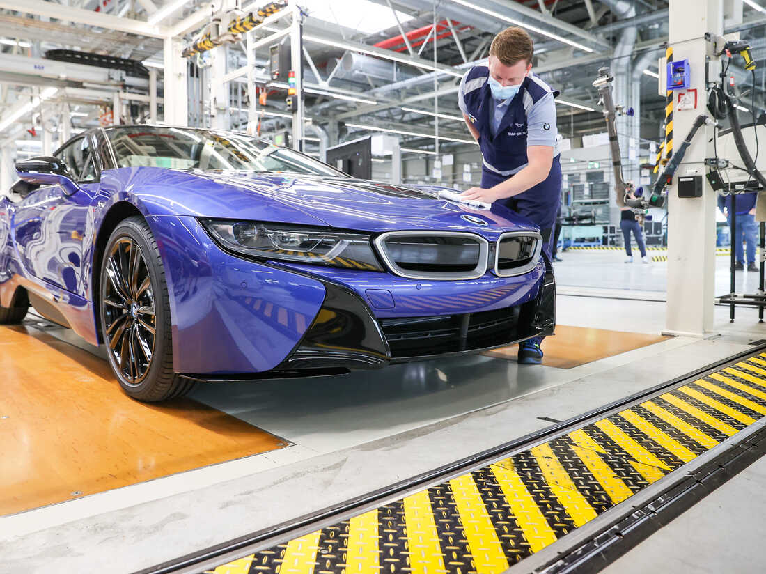 11 June 2020, Saxony, Leipzig: An employee wipes the last BMW i8 with a cloth at the end of the production line. (Photo by Jan Woitas/picture alliance via Getty Images)