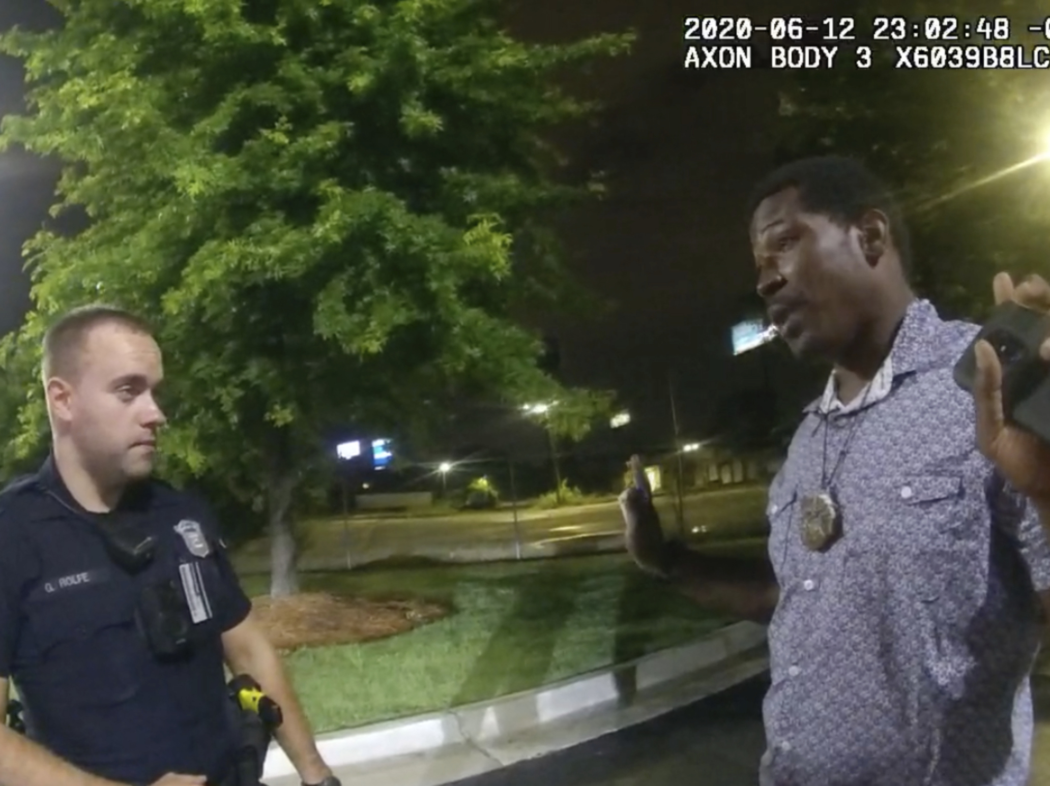 This screen grab taken from body camera video provided by the Atlanta Police Department shows Rayshard Brooks speaking with Officer Garrett Rolfe in the parking lot of a Wendy's restaurant on June 12 in Atlanta. Rolfe has been fired following the fatal shooting of Brooks, and a second officer has been placed on administrative duty. (Atlanta Police Department via AP)