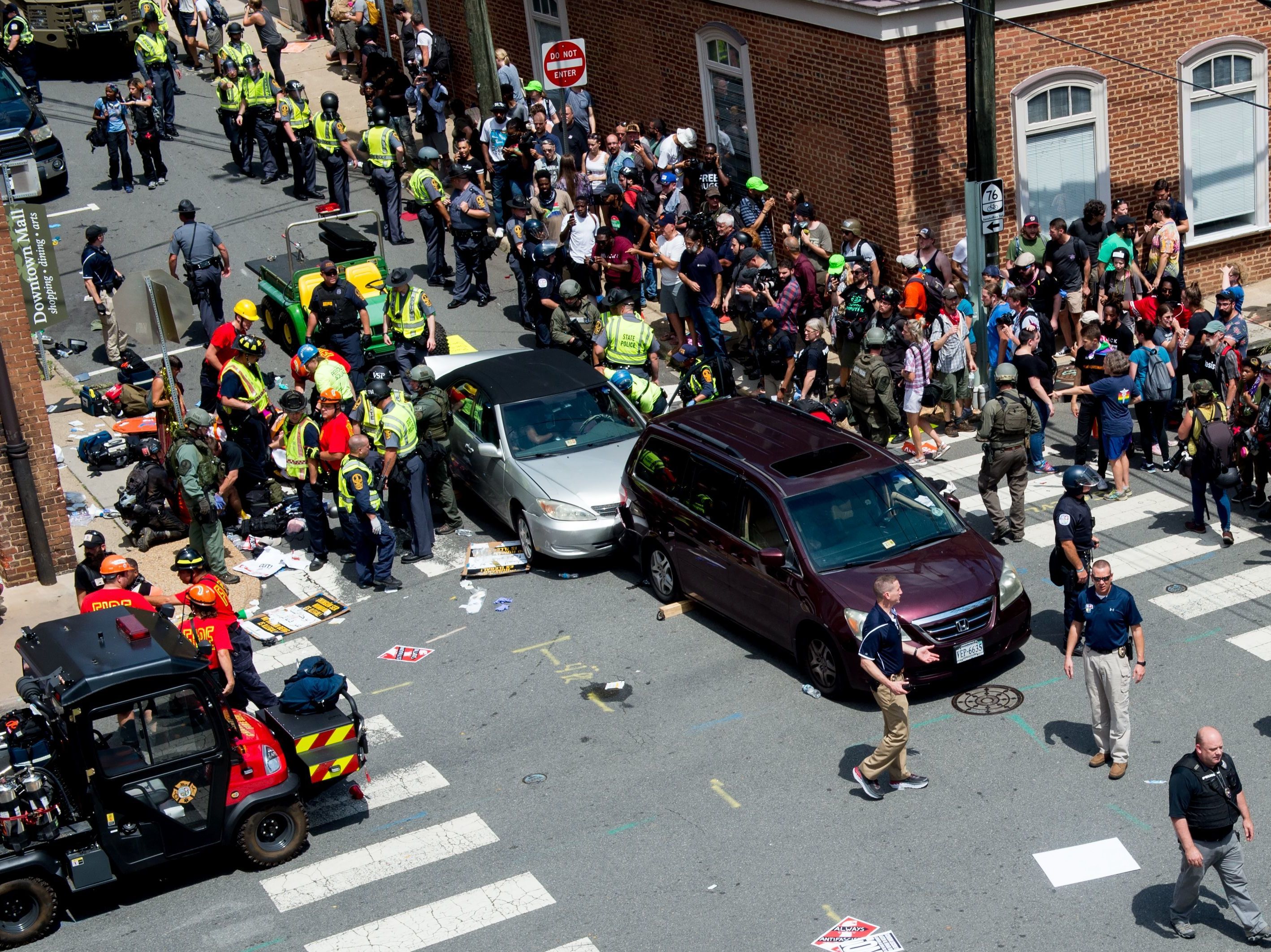 People receive first-aid after a car ran into a crowd of protesters in Charlottesville, Va., on Aug. 12, 2017. Terrorism researchers say right-wing extremists are turning cars into weapons in response to the ongoing protests against police misconduct. (AFP via Getty Images)