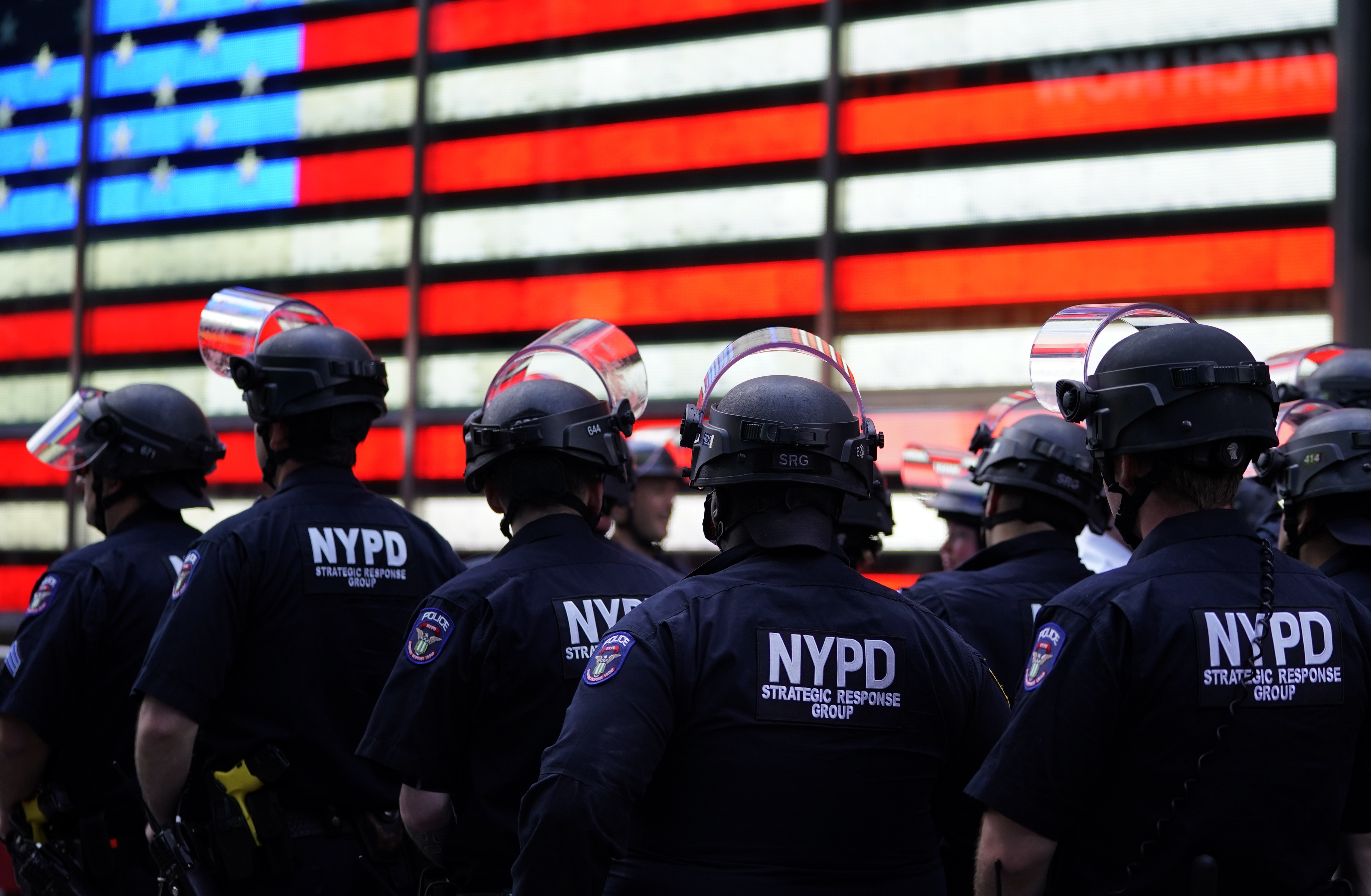 New York City police officers watch demonstrators in Times Square on June 1 during a Black Lives Matter protest. (AFP via Getty Images)