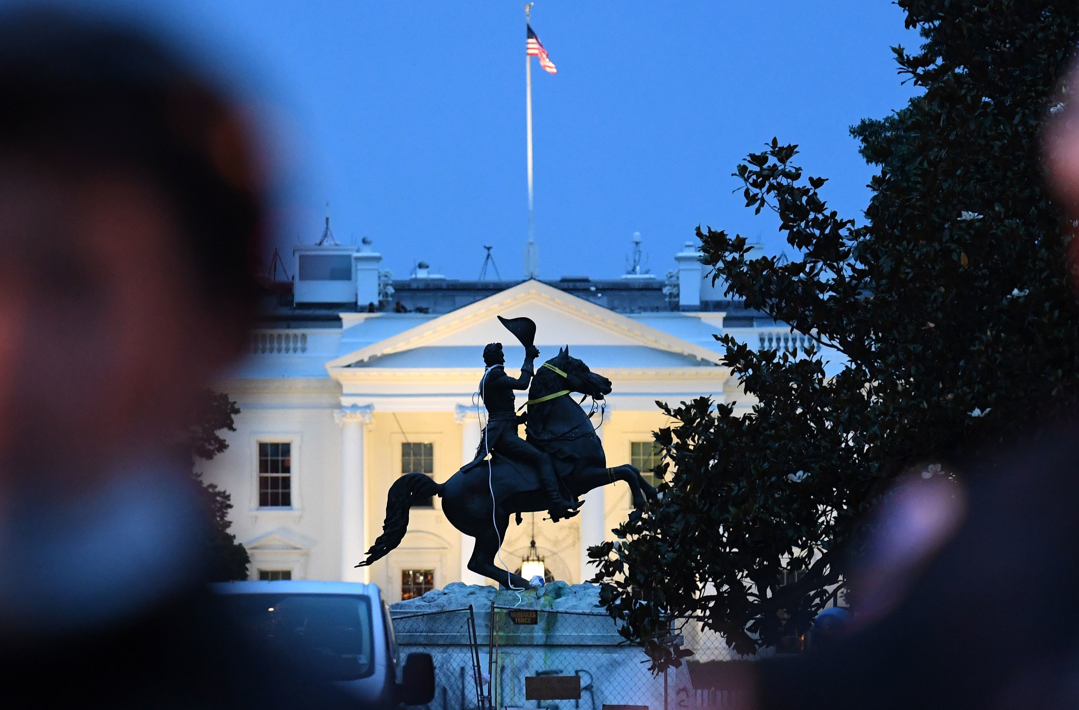 Police officers stand guard with the statue of former President Andrew Jackson after protesters tried to topple it Monday in Lafayette Square in Washington, D.C. (AFP via Getty Images)
