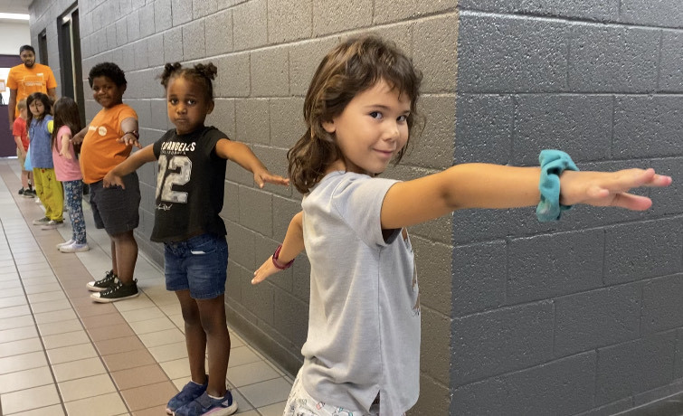 To help with social distancing, children at Valley of the Sun YMCA sites in Arizona were taught to make &quot;airplane arms&quot; when standing in line. (Valley of the Sun YMCA)