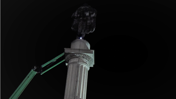 Crews make preparations for removal of the statue of former U.S. Vice President and slavery advocate John C. Calhoun early Wednesday in Charleston, S.C.