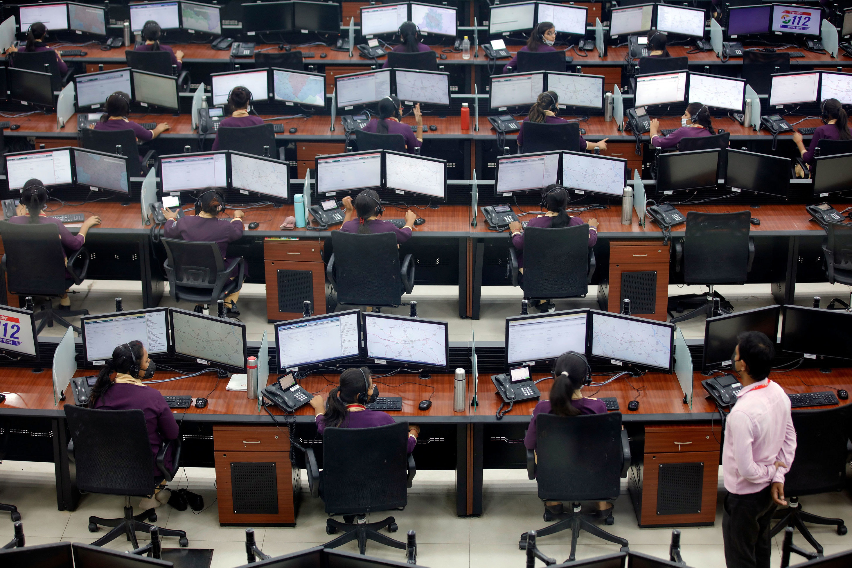 Employees work in a call center run by Uttar Pradesh state police in Lucknow, India, in April. (Reuters)