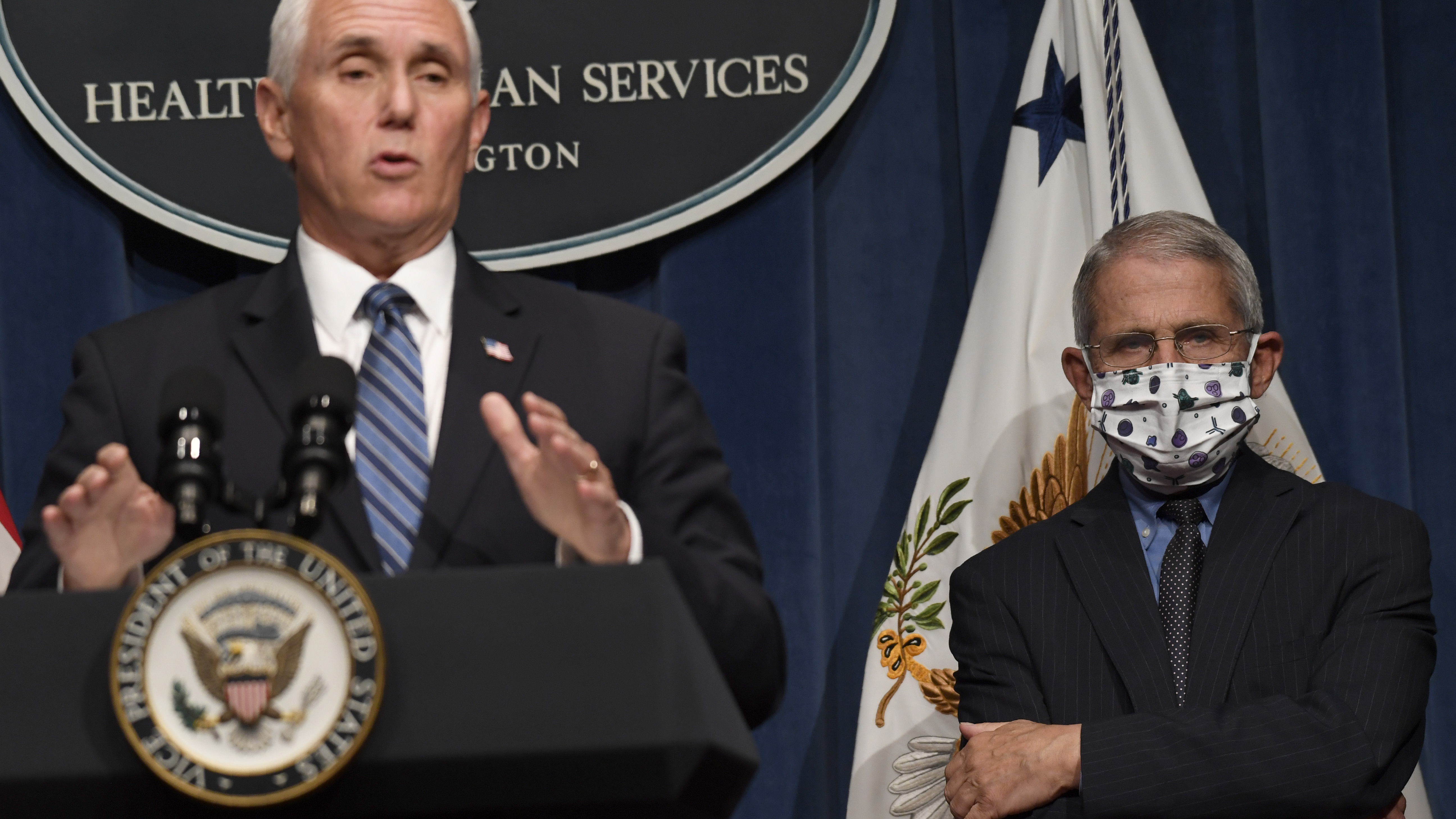 Dr. Anthony Fauci, right, director of the National Institute of Allergy and Infectious Diseases, listens as Vice President Pence speaks during a news conference with the Coronavirus Task Force at the Department of Health and Human Services on Friday. Global deaths from the virus are about to hit half a million.