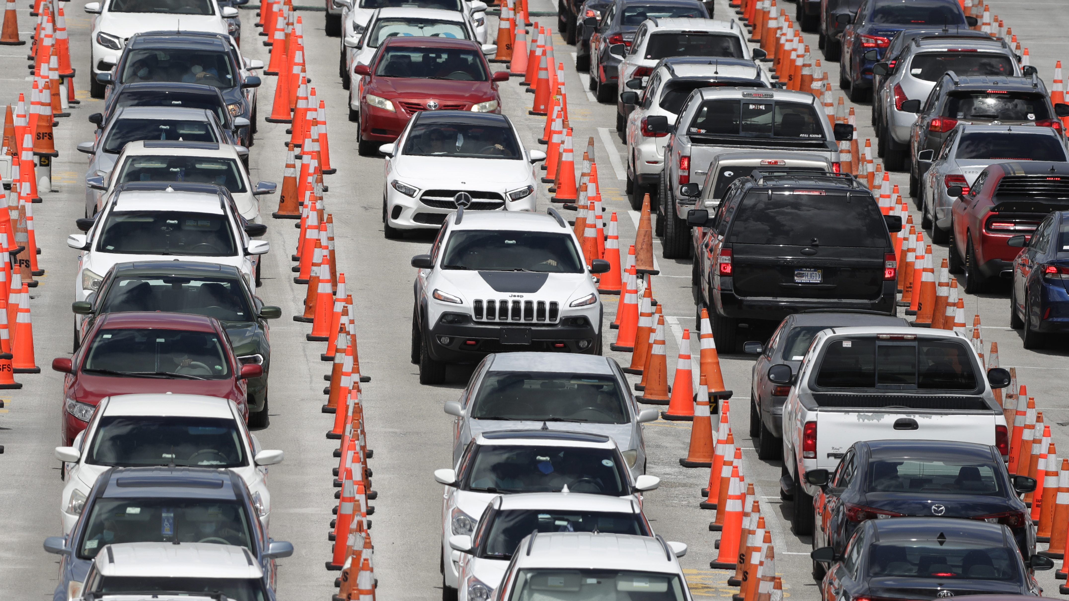 Cars line up for coronavirus testing outside of Hard Rock Stadium in Miami Gardens, Fla. Florida is one of many states reporting spikes in COVID-19 cases in recent days, as the number of confirmed cases worldwide tops 10 million.