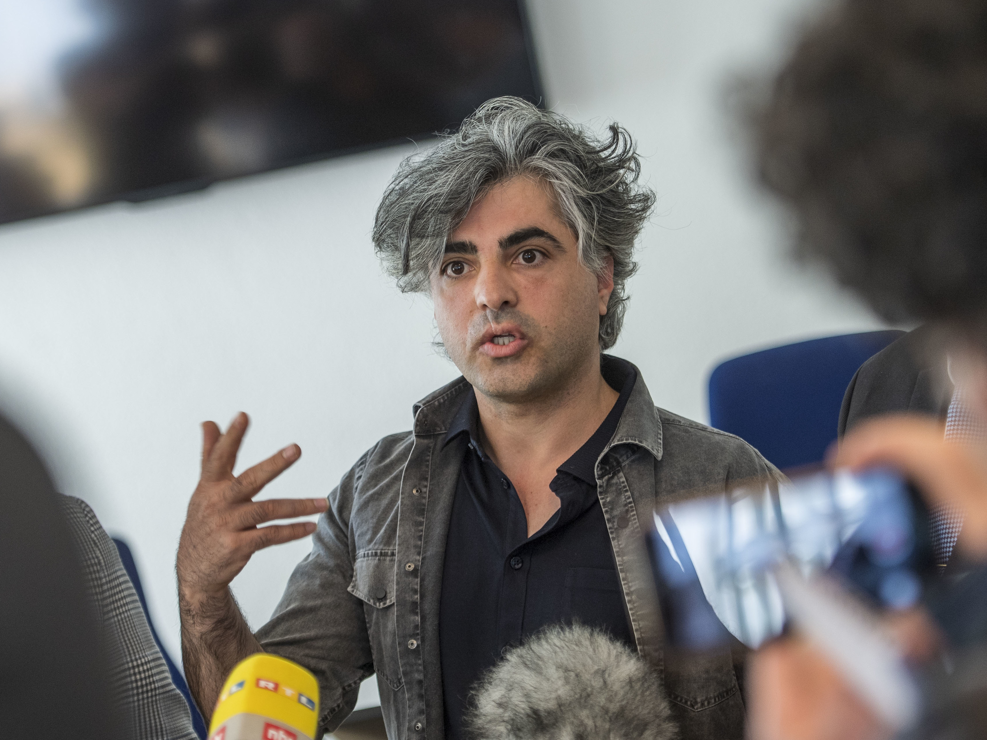 Syrian Oscar-nominated filmmaker Feras Fayyad answers journalists' questions outside a courtroom during a break in a trial against two Syrian defendants accused of state-sponsored torture in Syria, on April 23, in Koblenz, Germany. (AFP via Getty Images)