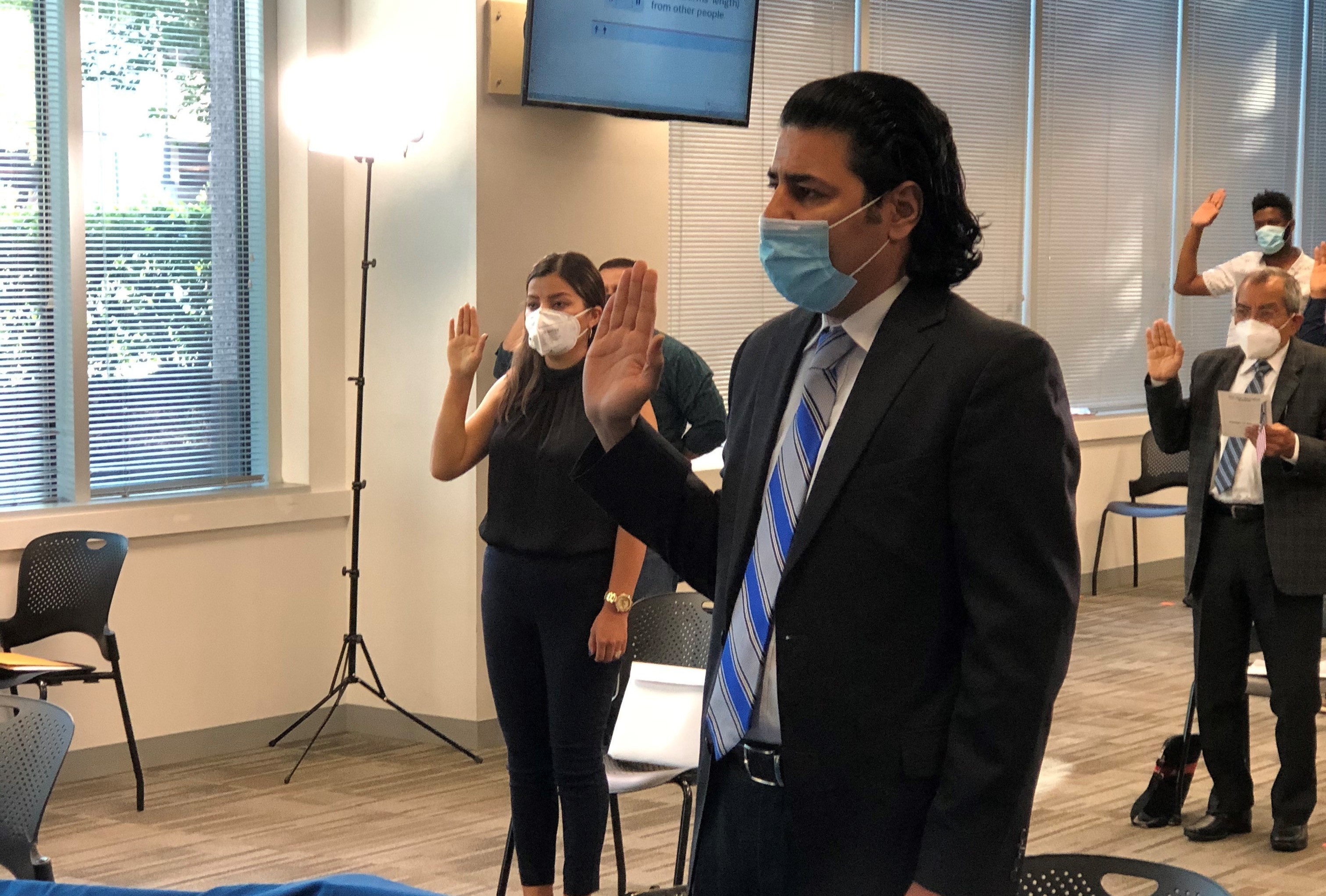 Janis Shinwari takes his oath Monday as a naturalized U.S. citizen in a ceremony in Fairfax, Va. He worked eight years as an Afghan interpreter with the U.S. military in his homeland, and was credited with saving the lives of five U.S. troops. (NPR)