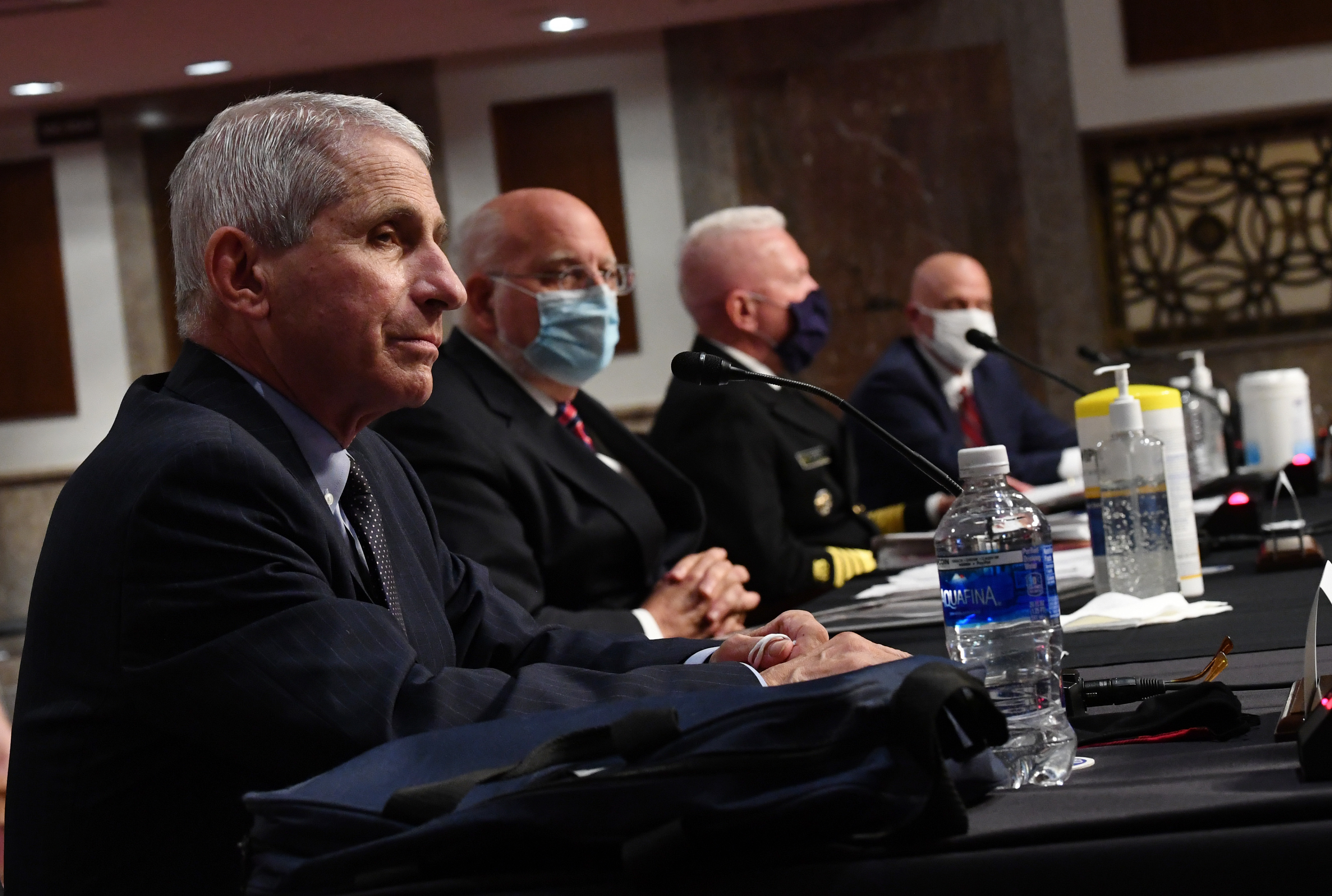 Dr. Anthony Fauci and other top government health officials testify before the Senate health and education committee on Tuesday. (Pool/AFP via Getty Images)