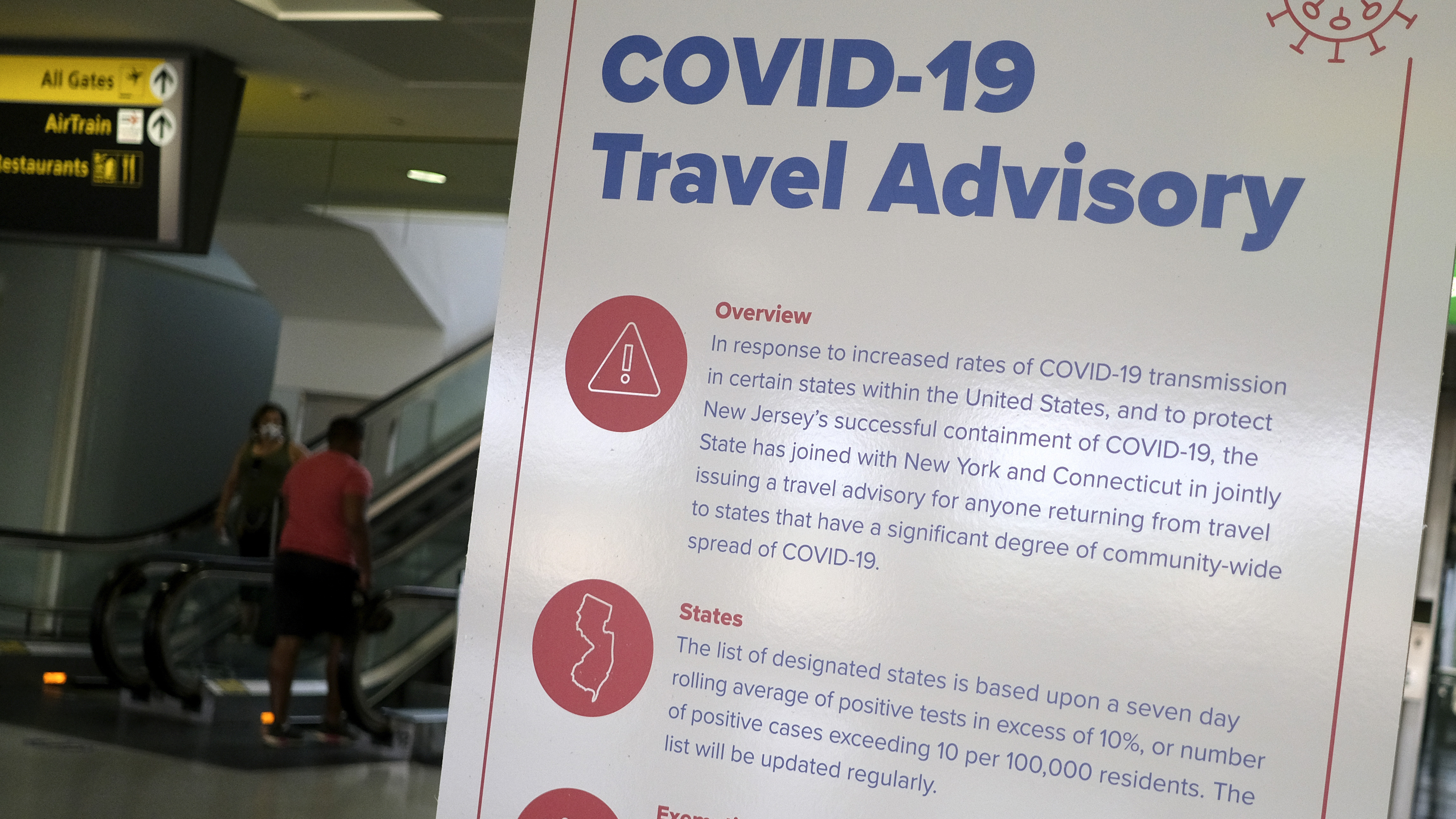 A sign at Newark Liberty International Airport warns airline passengers about a travel advisory that applies to people arriving in New Jersey from certain states. Visitors from Alabama, Arkansas, Arizona, California, Florida, Georgia, Iowa, Idaho, Louisiana, Mississippi, Nevada, North Carolina, South Carolina, Tennessee, Texas and Utah should self-quarantine for two weeks. (AP)