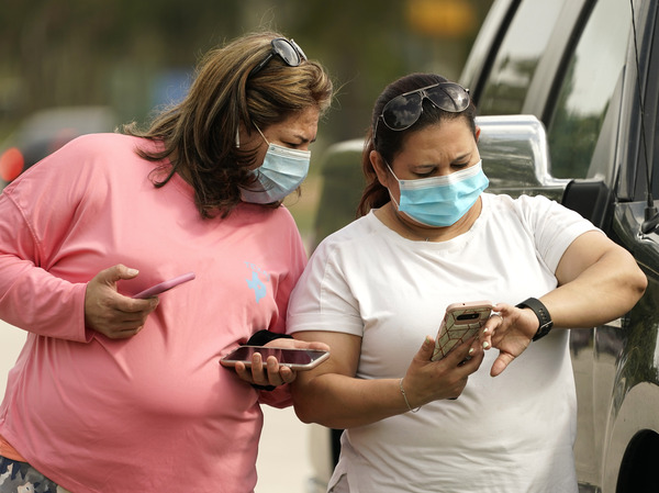 Women wear masks in Houston Wednesday. Harris County requires any business providing goods or services to require all employees and visitors to wear face coverings in areas of close proximity to co-workers or the public, at least through Aug. 26.