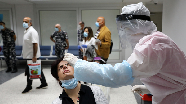 Passengers are tested for COVID-19 at Beirut International Airport on July 1.
