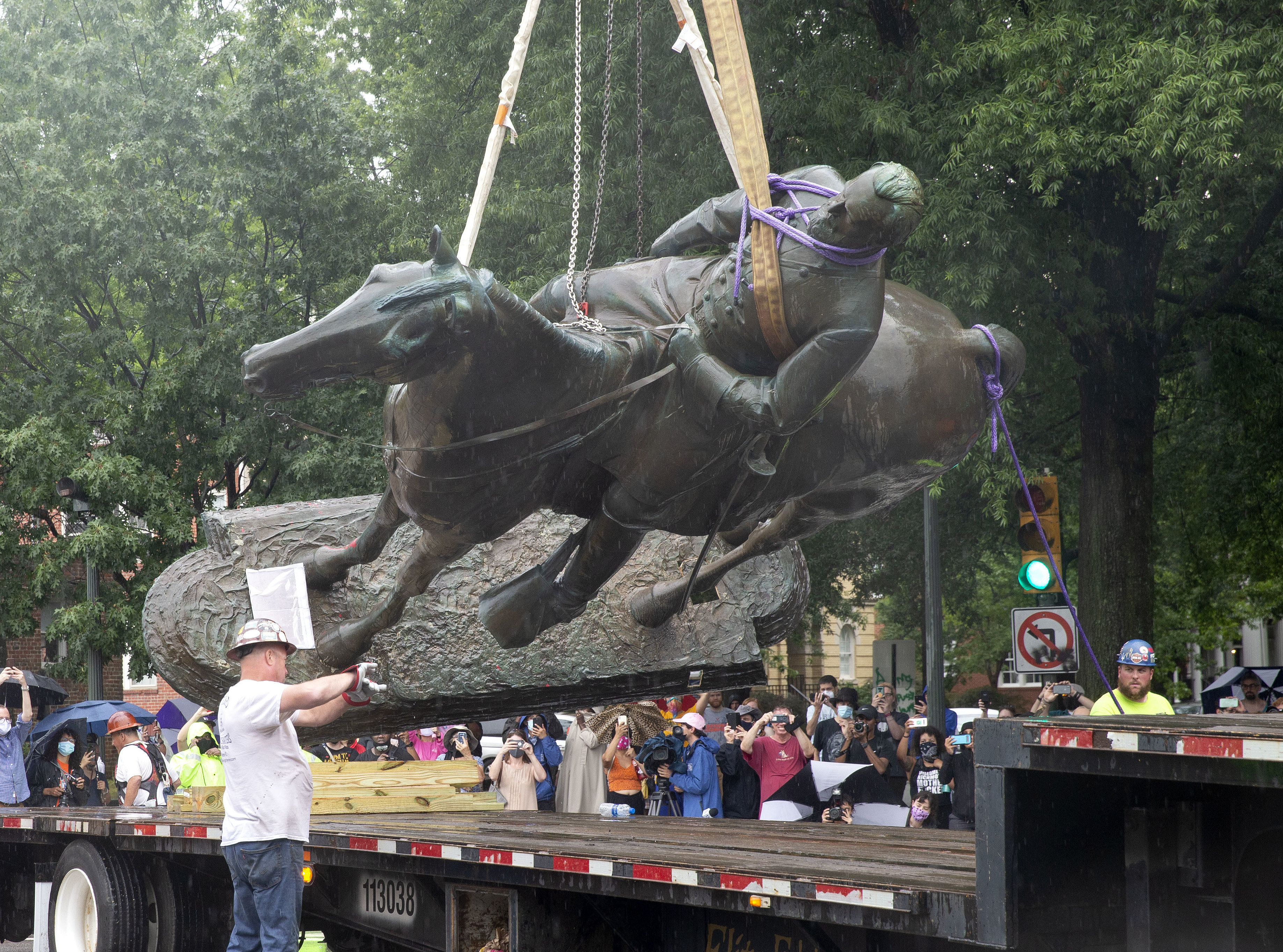 A Stonewall Jackson statue is loaded on a truck after being removed from Monument Avenue in Richmond, Va., on Wednesday. (AFP via Getty Images)