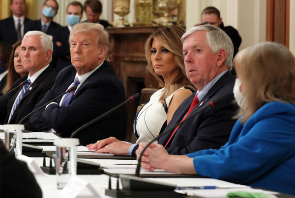 With Vice President Pence and first lady Melania Trump at his side, President Trump participates in a White House event Tuesday with students, teachers and administrators about how to reopen schools safely during the pandemic.