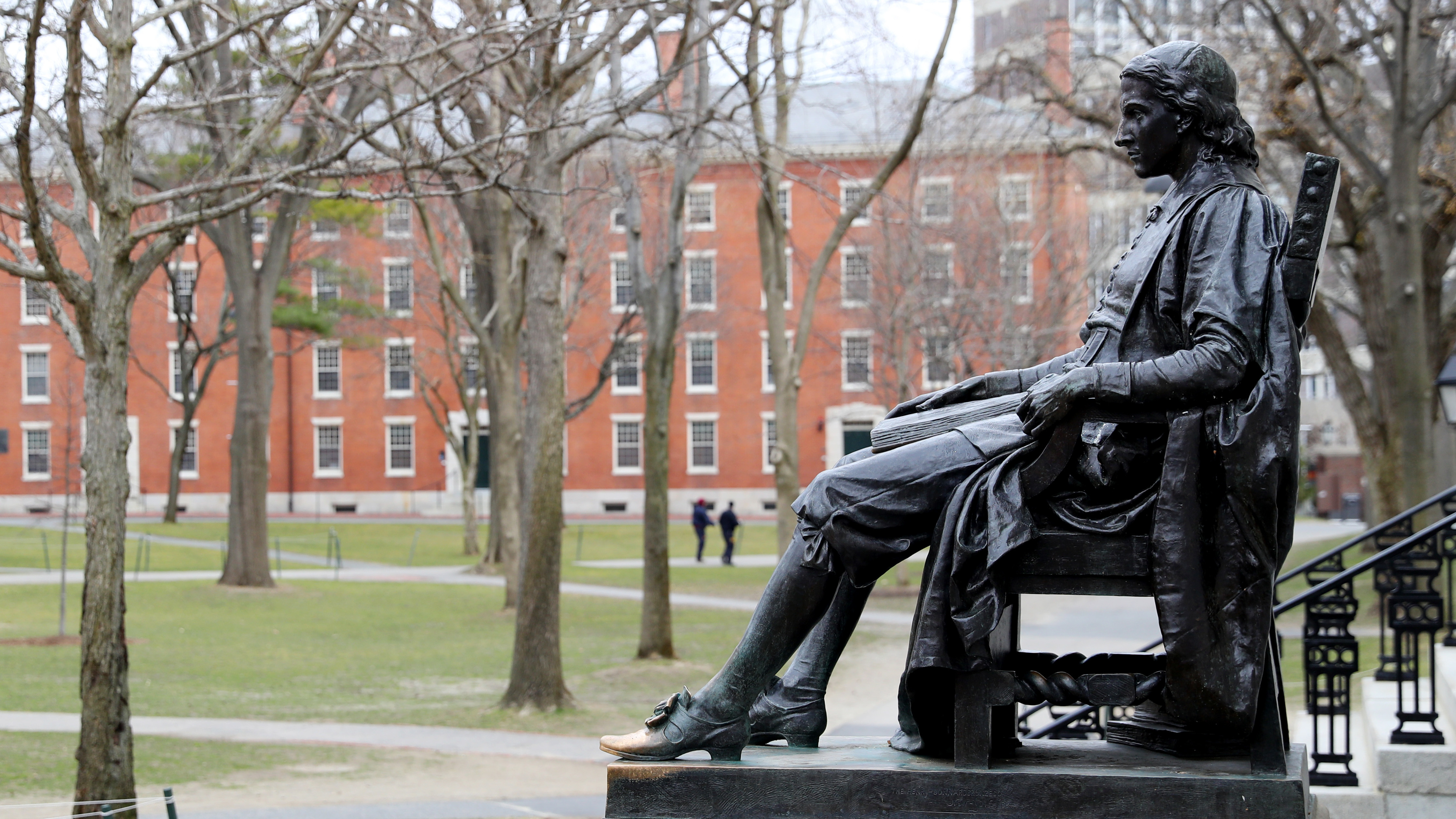 A statue of John Harvard, namesake of the university, overlooks the campus earlier this year. Harvard University joined the Massachusetts Institute of Technology in suing the federal government over its policies on international students Wednesday. (Getty Images)